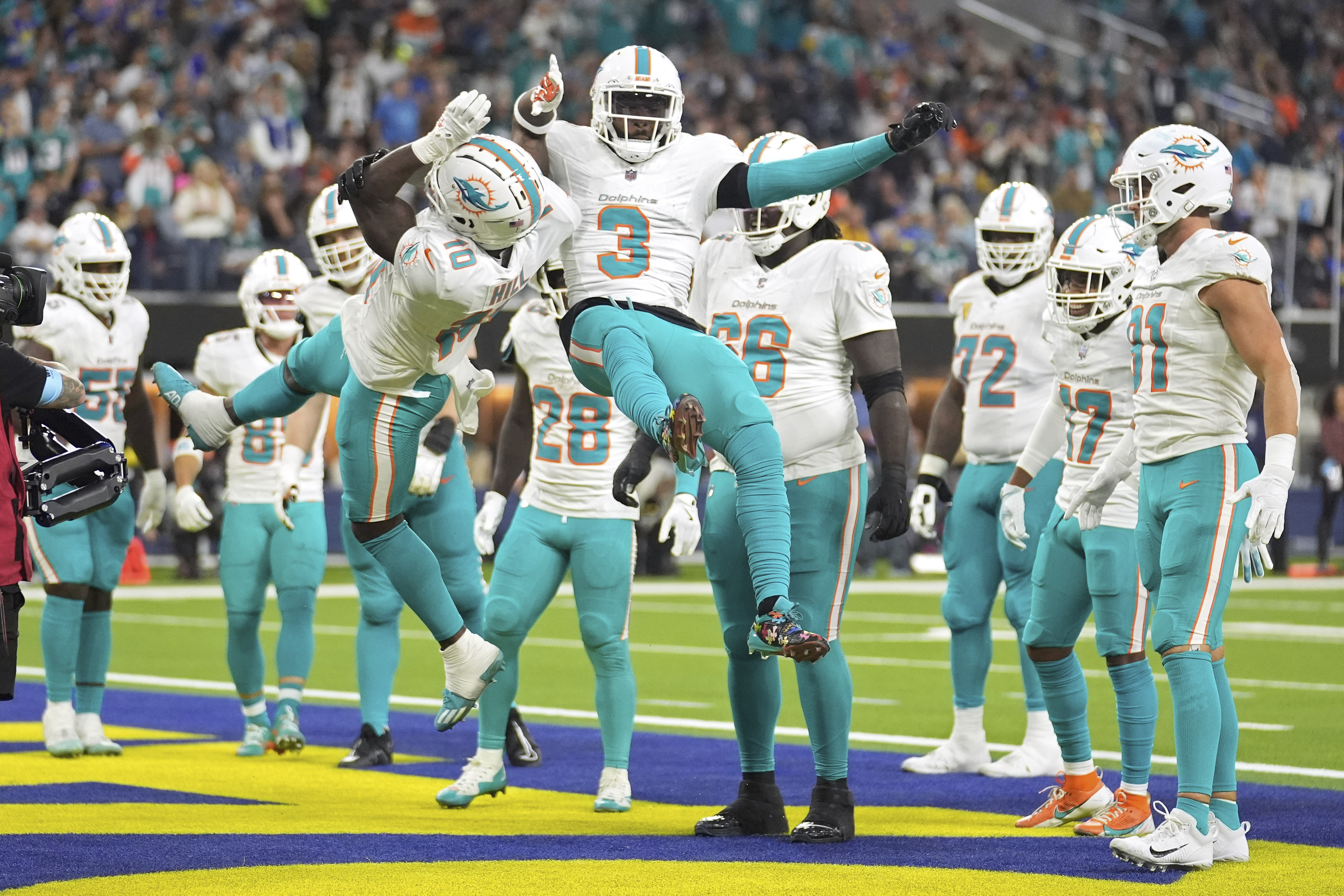Miami Dolphins wide receiver Tyreek Hill, left, celebrates his touchdown with wide receiver Odell Beckham Jr. during the second half of an NFL football game against the Los Angeles Rams, Monday, Nov. 11, 2024, in Inglewood, Calif.