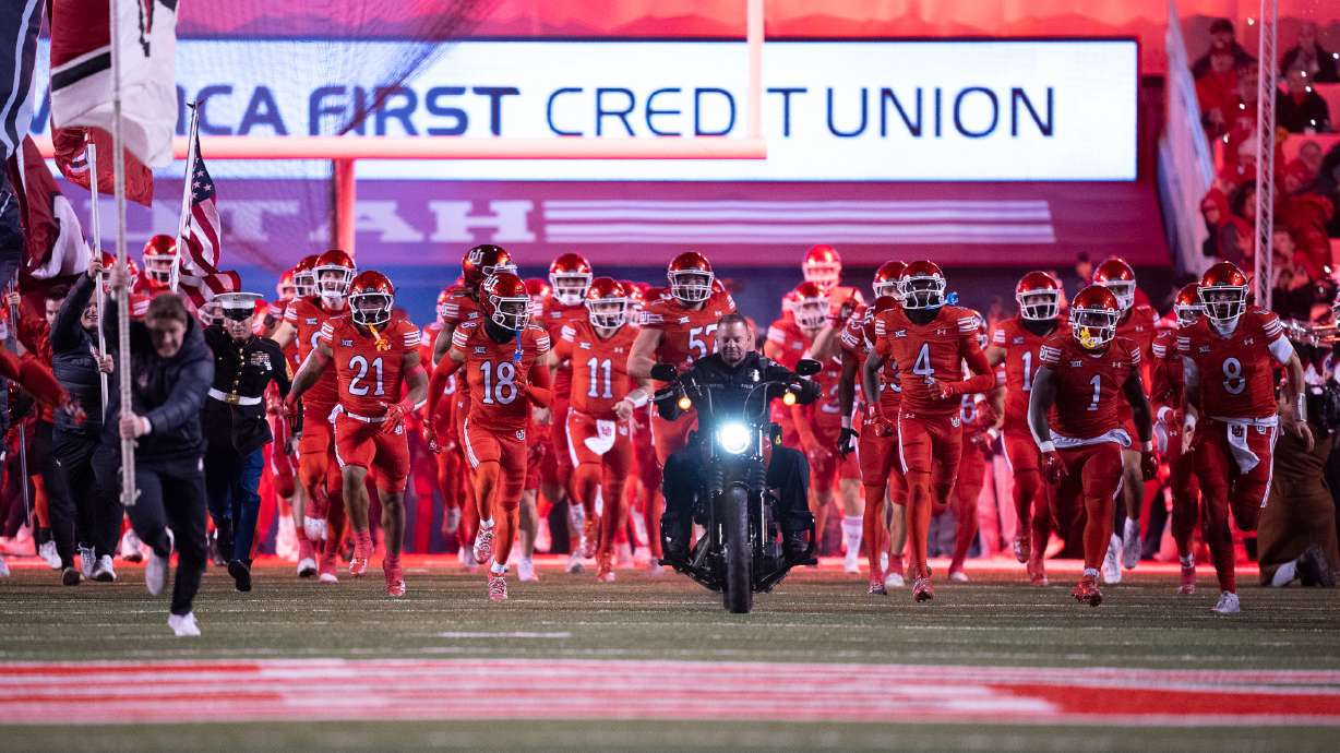 Utah football players run onto the field at Rice-Eccles Stadium on Nov. 9, 2024.