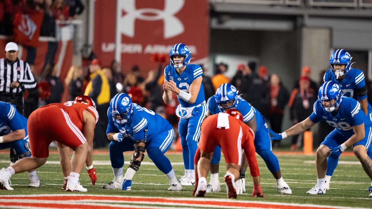 BYU quarterback Jake Retzlaff prepares to receive the ball in a game against rival Utah at Rice-Eccles Stadium on Nov. 9, 2024.
