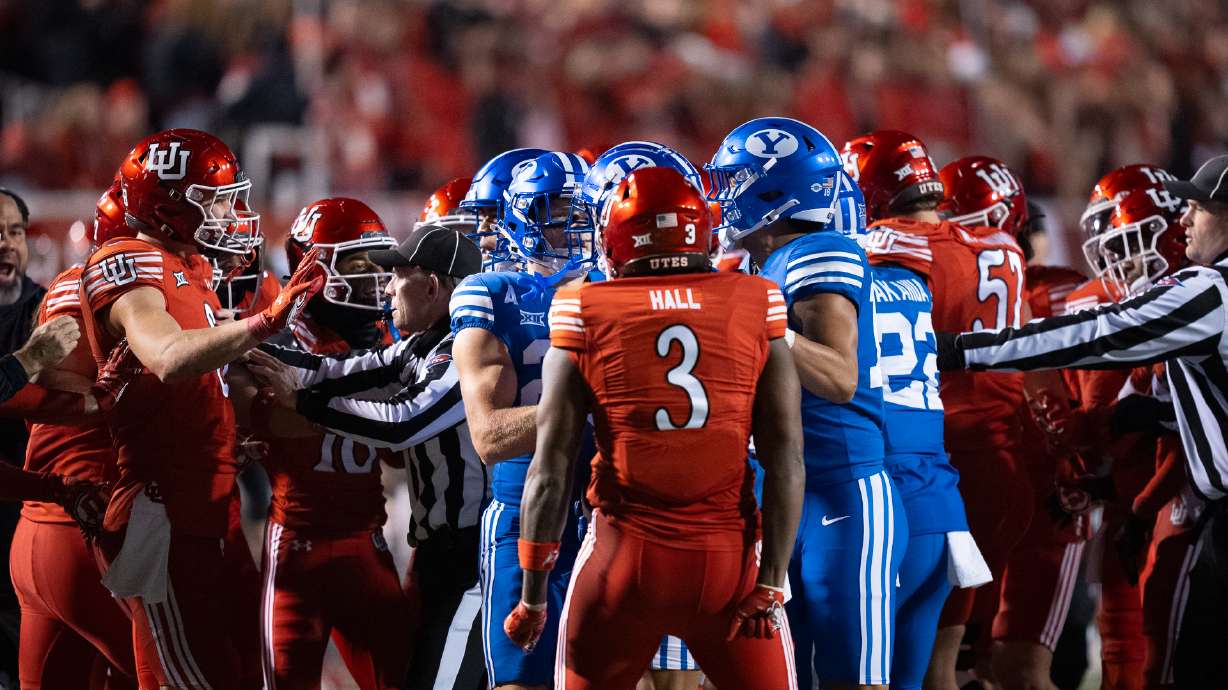 BYU and Utah football players confront each other during a rivalry matchup at Rice-Eccles Stadium on Nov. 9, 2024.