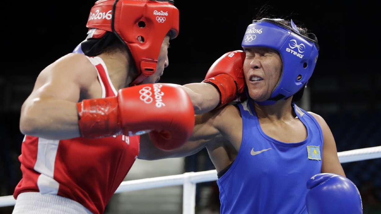 FILE -France's Sarah Ourahmoune, left, fights Kazakhstan's Zhaina Shekerbekova during a women's flyweight 51-kg quarterfinals boxing match at the 2016 Summer Olympics in Rio de Janeiro, Brazil, Aug. 16, 2016.