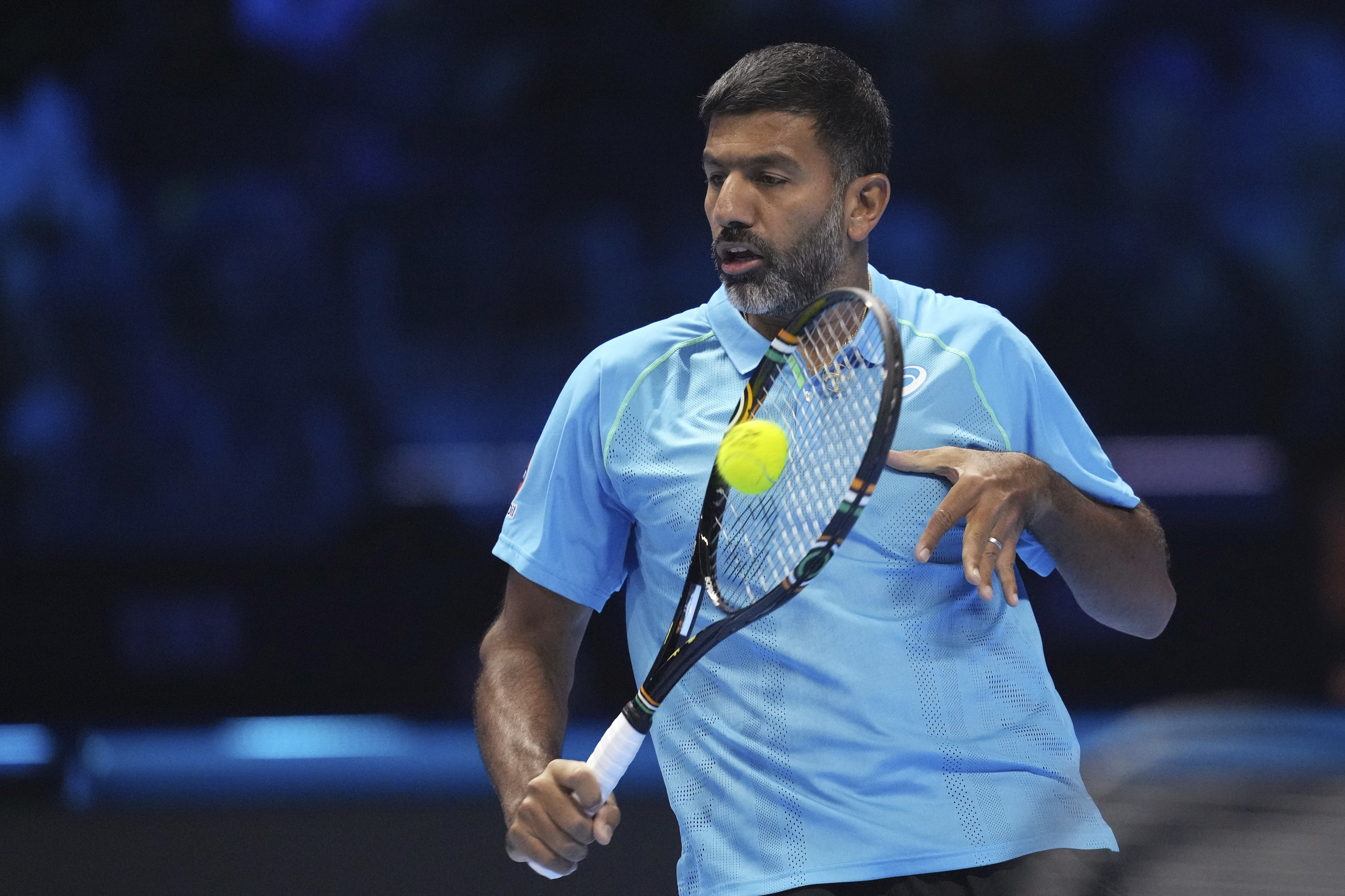 India's Rohan Bopanna returns the ball with his teammate Australia's Matthew Ebden to Italy's Simone Bolelli and Andrea Vavassori during their doubles tennis match of the ATP World Tour Finals at the Inalpi Arena, in Turin, Italy, Monday, Nov. 11, 2024.