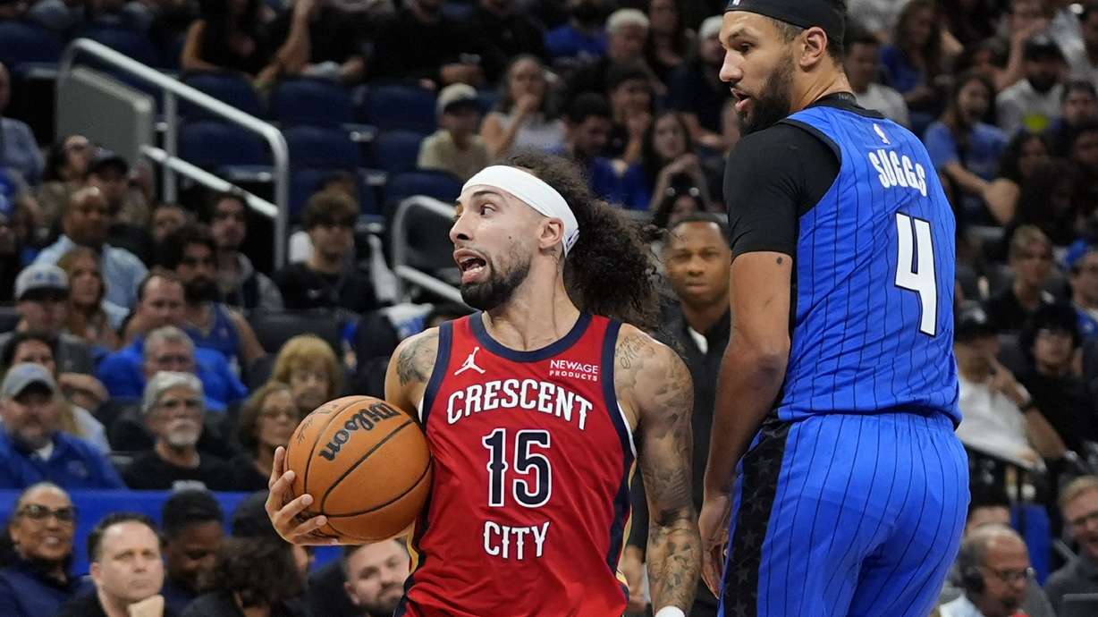 New Orleans Pelicans guard Jose Alvarado (15) looks to pass the ball as he gets around Orlando Magic guard Jalen Suggs (4) during the second half of an NBA basketball game, Friday, Nov. 8, 2024, in Orlando, Fla.