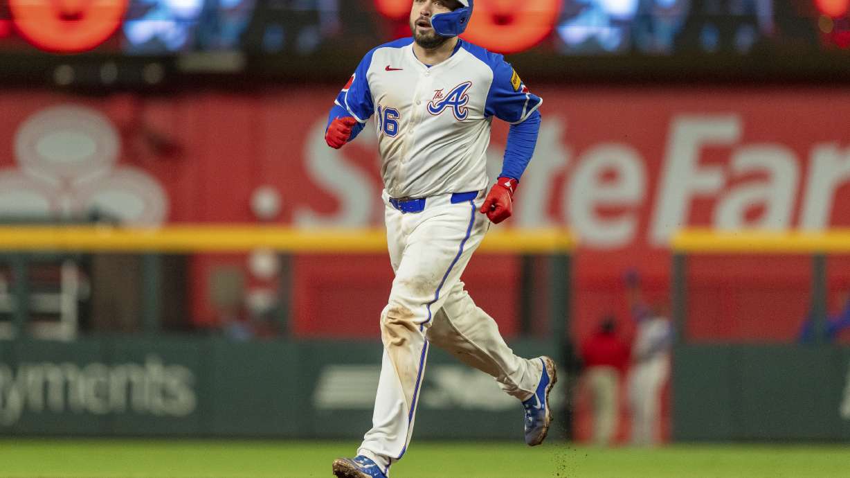FILE - Atlanta Braves' Travis d'Arnaud rounds second base after hitting a walkoff home run to win a baseball game against the Kansas City Royals, Sept. 28, 2024, in Atlanta.