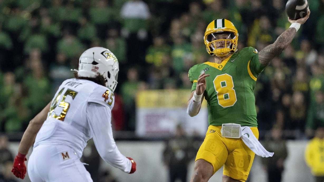 Oregon quarterback Dillon Gabriel (8) throws the ball as Maryland linebacker Kellan Wyatt (45) defends during the second half of an NCAA college football game on Saturday, Nov. 9, 2024, in Eugene, Ore. Oregon won 39-18.