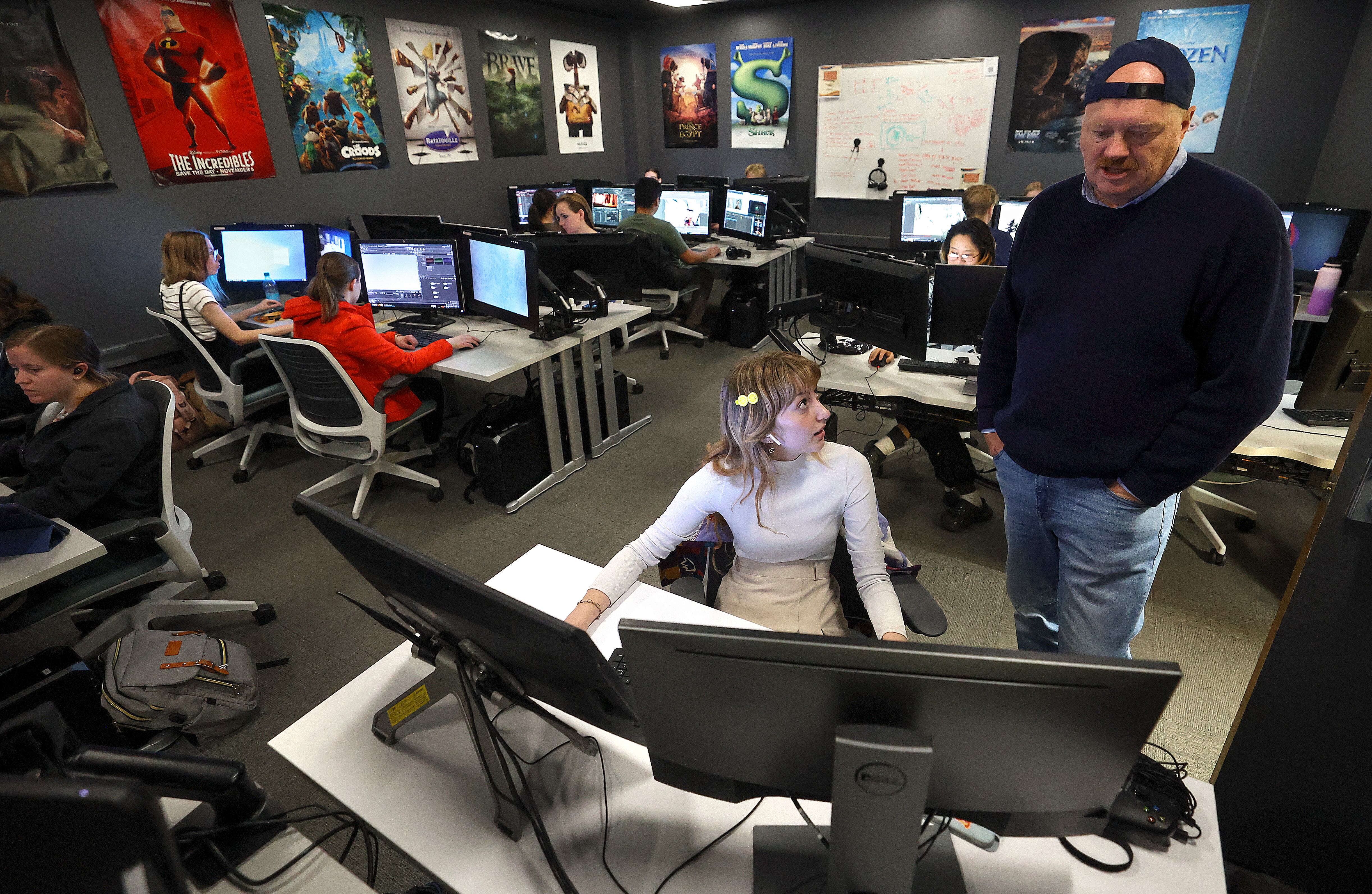BYU junior Madison Jensen, left, talks to Kelly Loosli, head of the BYU Animation Program, as she works on computer-generated lighting homework at BYU in Provo on Monday.