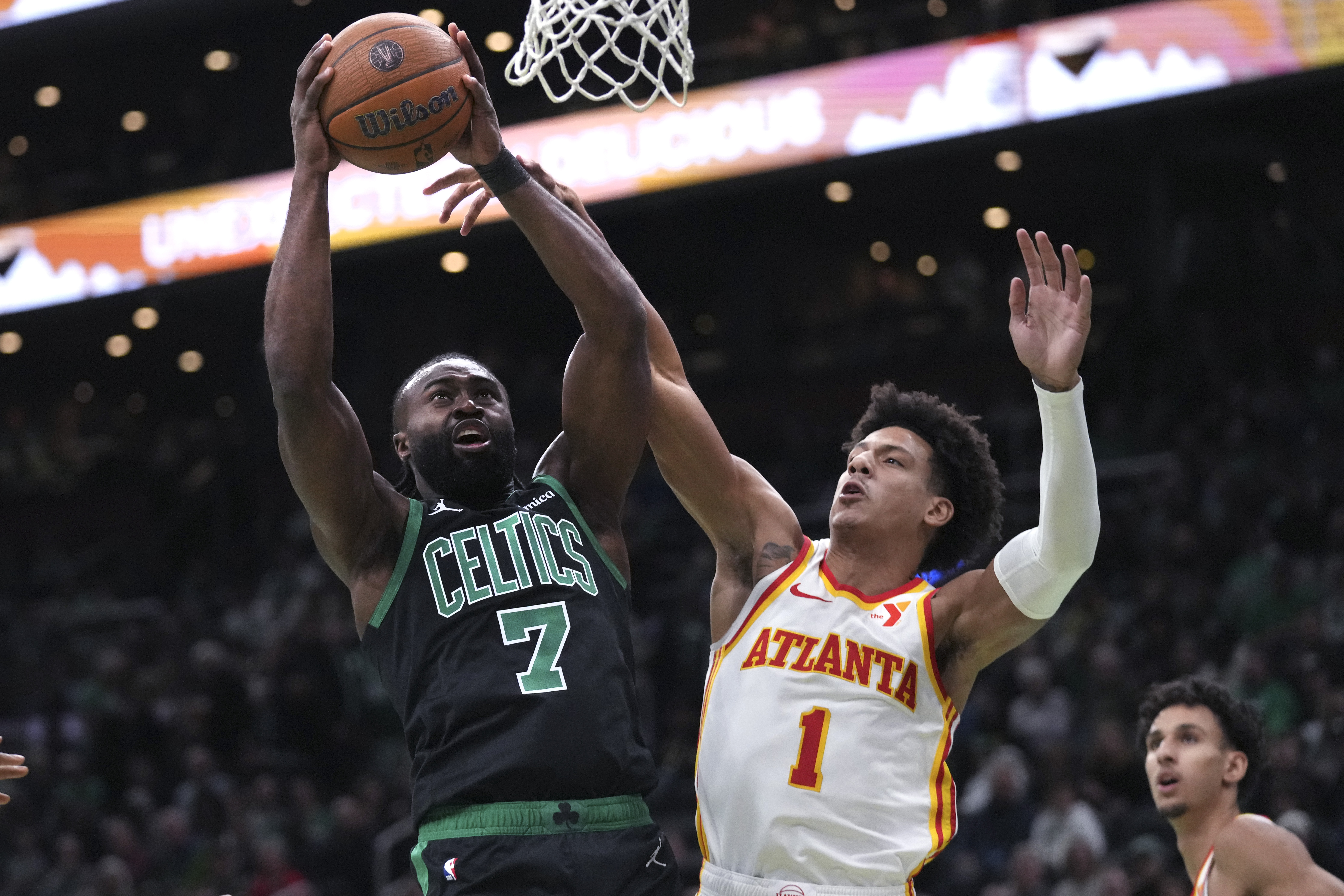 Boston Celtics guard Jaylen Brown (7) drives to the basket against Atlanta Hawks forward Jalen Johnson (1) during the first half of an Emirates NBA Cup basketball game, Tuesday, Nov. 12, 2024, in Boston.
