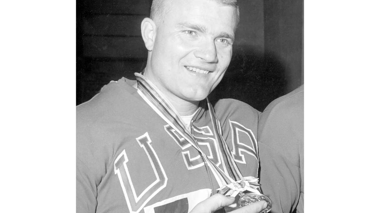 FILE - Americans Dallas Long poses with the gold medal he won in the 1964 Olympics in Tokyo in the shot put event competition Oct. 17, 1964.