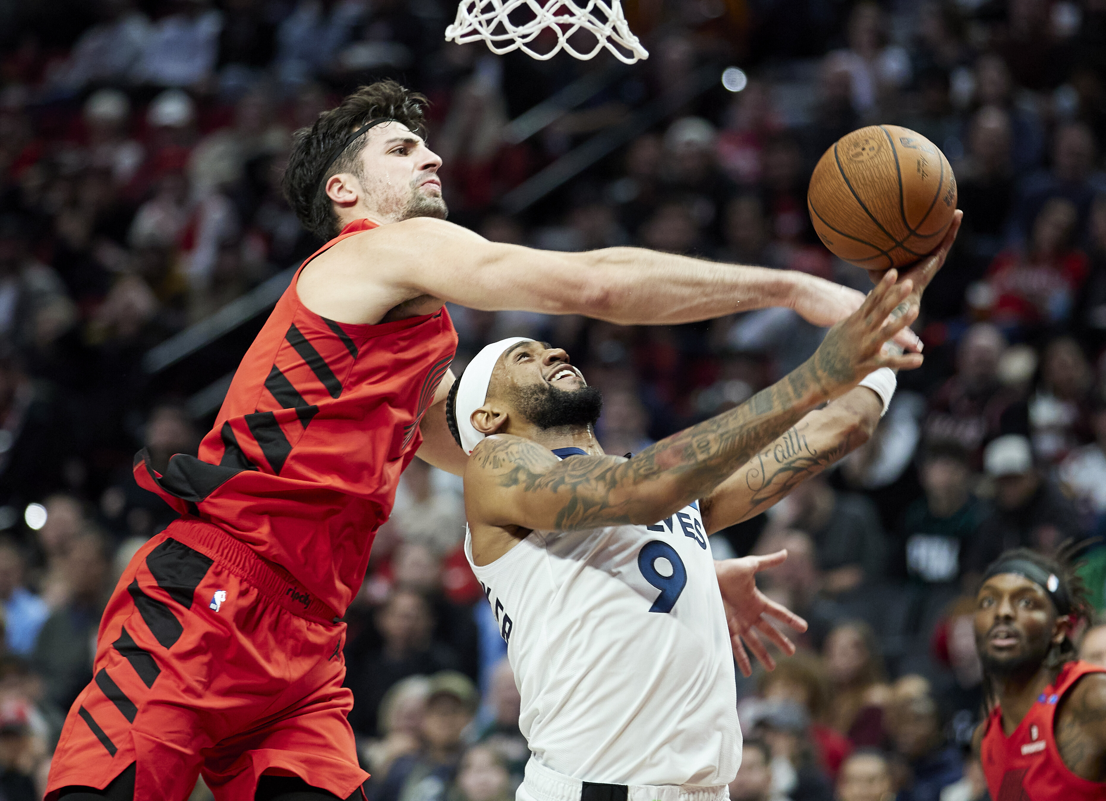 Minnesota Timberwolves guard Nickeil Alexander-Walker (9) is fouled by Portland Trail Blazers forward Deni Avdija, left, during the second half of an Emirates NBA Cup basketball game in Portland, Ore., Tuesday, Nov. 12, 2024.