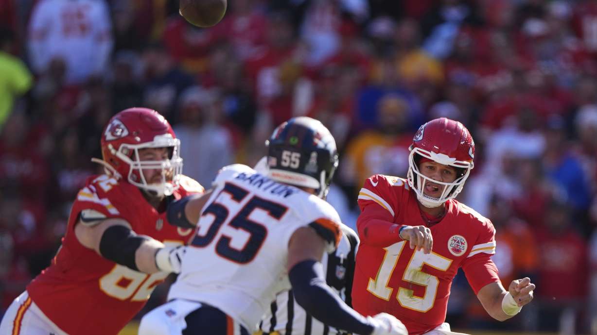 Kansas City Chiefs quarterback Patrick Mahomes (15) throws over Denver Broncos inside linebacker Cody Barton (55) during the first half of an NFL football game Sunday, Nov. 10, 2024, in Kansas City, Mo.