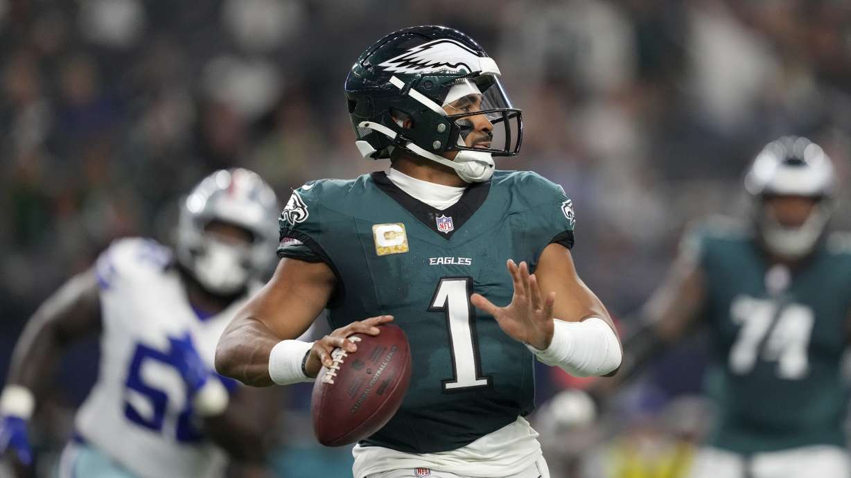 Philadelphia Eagles' Jalen Hurts prepares to throw a pass in the second half of an NFL football game against the Dallas Cowboys in Arlington, Texas, Sunday, Nov. 10, 2024.