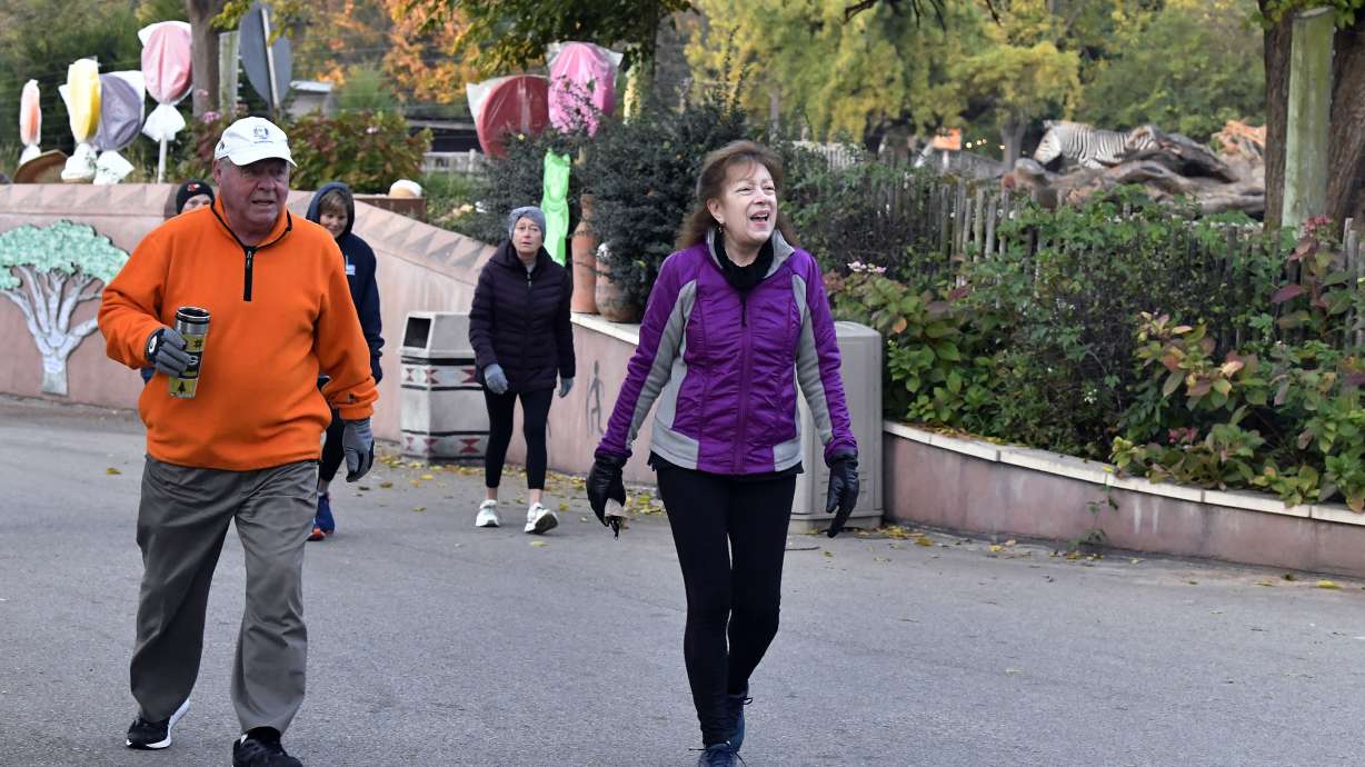 Members of the Get Healthy Walking Club walk the paths past the animal enclosures during the morning at the Louisville Zoo in Louisville, Ky., Oct. 18.