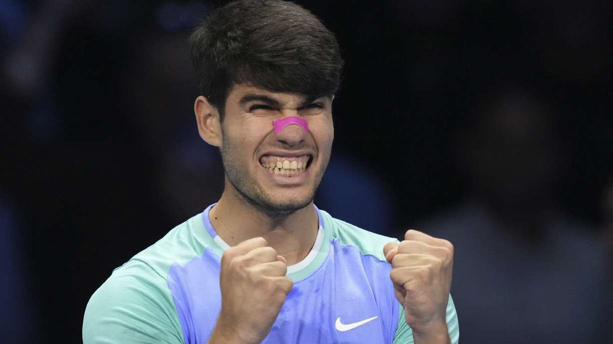 Spain's Carlos Alcaraz celebrates after winning the singles tennis match of the ATP World Tour Finals against Russia's Andrey Rublev, at the Inalpi Arena, in Turin, Italy, Wednesday, Nov. 13, 2024.