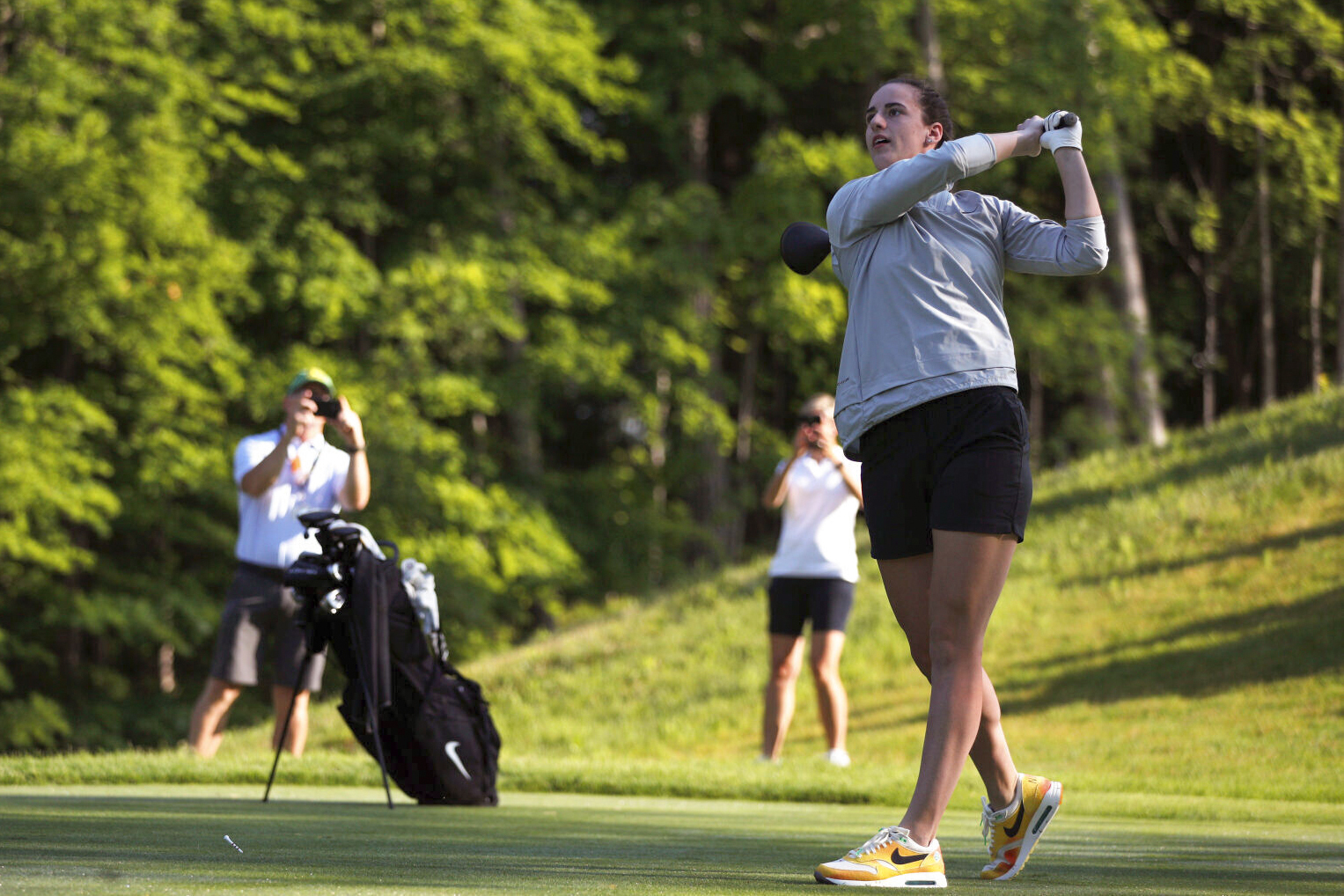 Caitlin Clark hits a golf ball during the John Deere Classic Pro-Am, July 5, 2023, at TPC Deere Run in Silvis, Illinois.