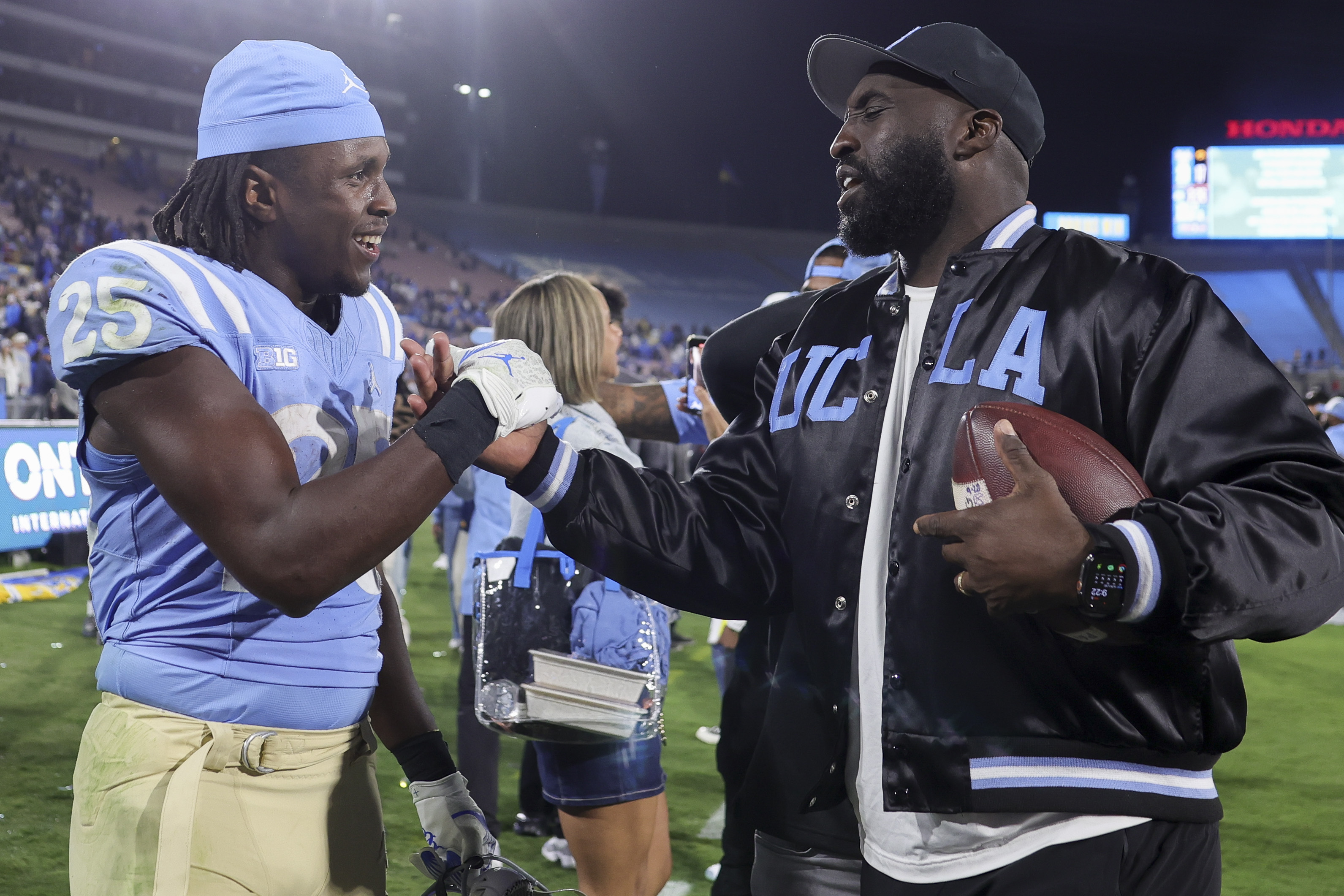 UCLA head coach DeShaun Foster, right, and running back T.J. Harden celebrate after the team's win against Iowa during an NCAA college football game, Friday, Nov. 8, 2024, in Pasadena, Calif.