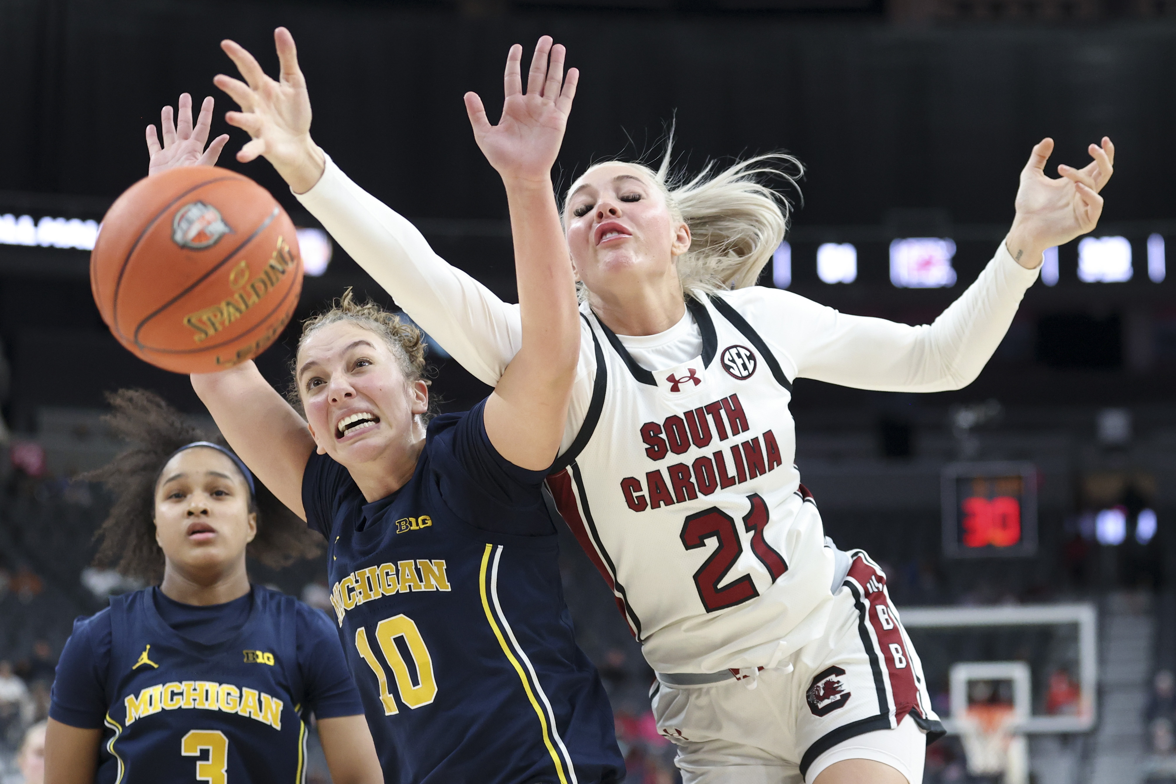 Michigan guard Jordan Hobbs (10) and South Carolina forward Chloe Kitts (21) contests for a rebound during the second half of an NCAA basketball game Monday, Nov. 4, 2024, in Las Vegas.