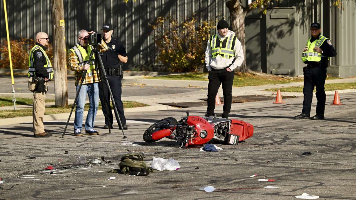 Police conduct an investigation after a fatal motorcycle versus vehicle crash on Main Street at 2335 South in South Salt Lake on Wednesday. Police have released the name of the woman killed in the crash.