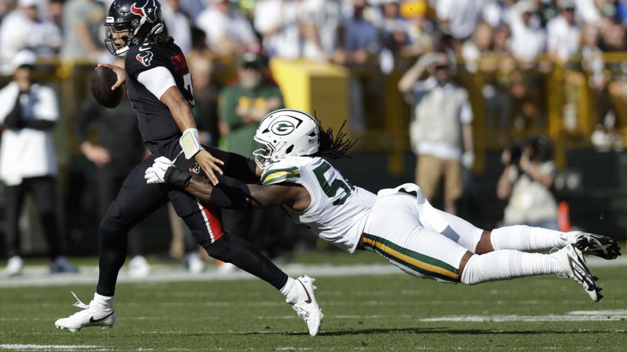 Houston Texans quarterback C.J. Stroud (7) tries to get past Green Bay Packers defensive end Rashan Gary (52) during the first half of an NFL football game, Sunday, Oct. 20, 2024, in Green Bay, Wis.