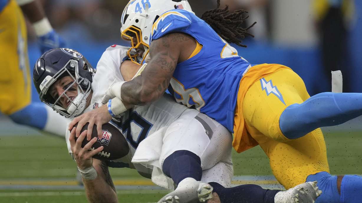 Los Angeles Chargers linebacker Bud Dupree (48) sacks Tennessee Titans quarterback Will Levis, left, during the second half of an NFL football game Sunday, Nov. 10, 2024, in Inglewood, Calif.