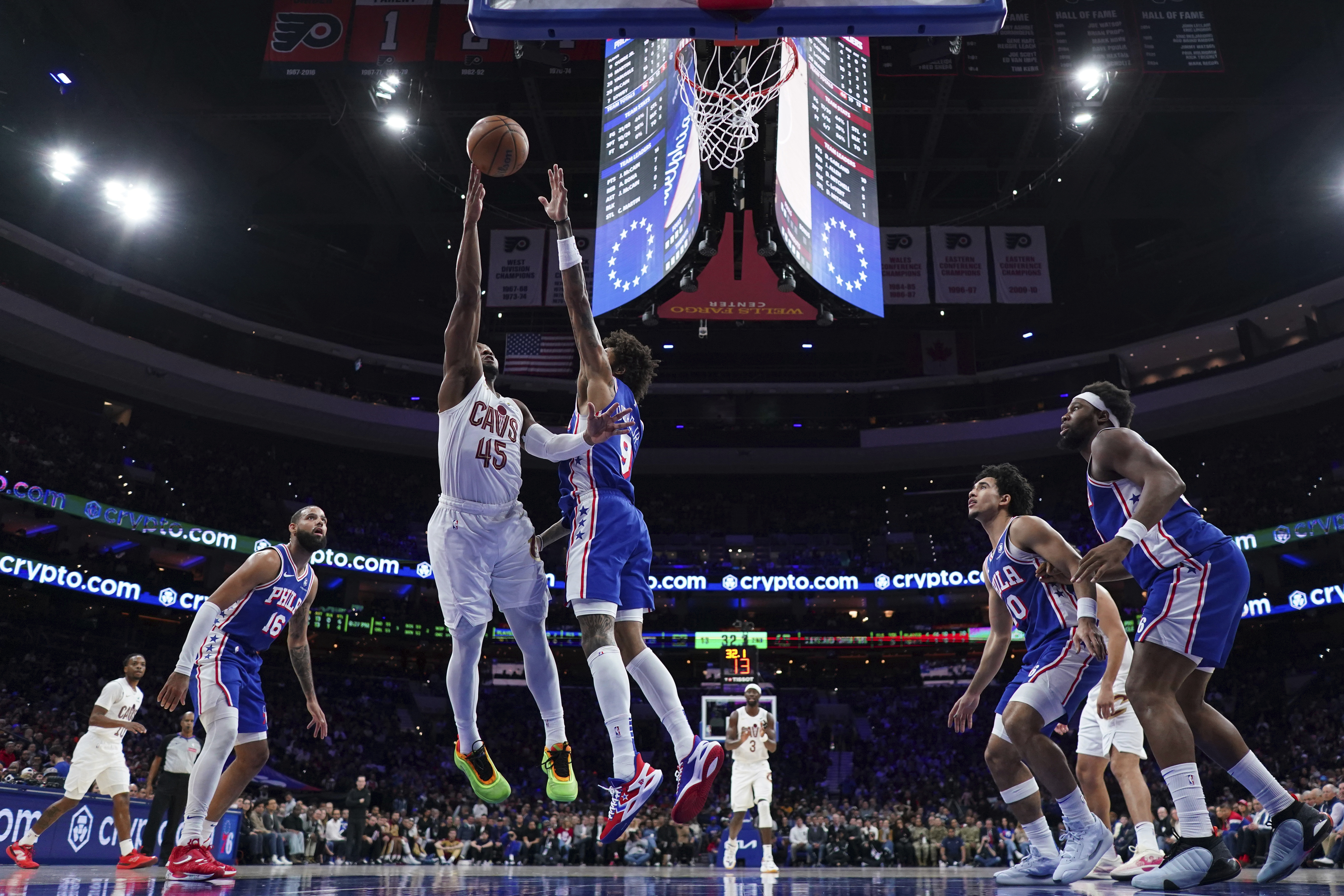 Cleveland Cavaliers' Donovan Mitchell (45) goes up for a shot against Philadelphia 76ers' Kelly Oubre Jr. (9) during the first half of an NBA basketball game, Wednesday, Nov. 13, 2024, in Philadelphia.