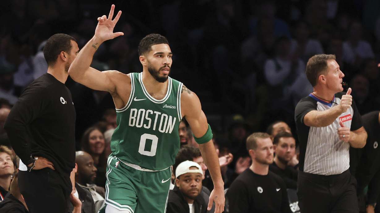 Boston Celtics' Jayson Tatum reacts after scoring a three-point basket in the first half of an NBA basketball game against the Brooklyn Nets, Wednesday, Nov. 13, 2024, in New York.