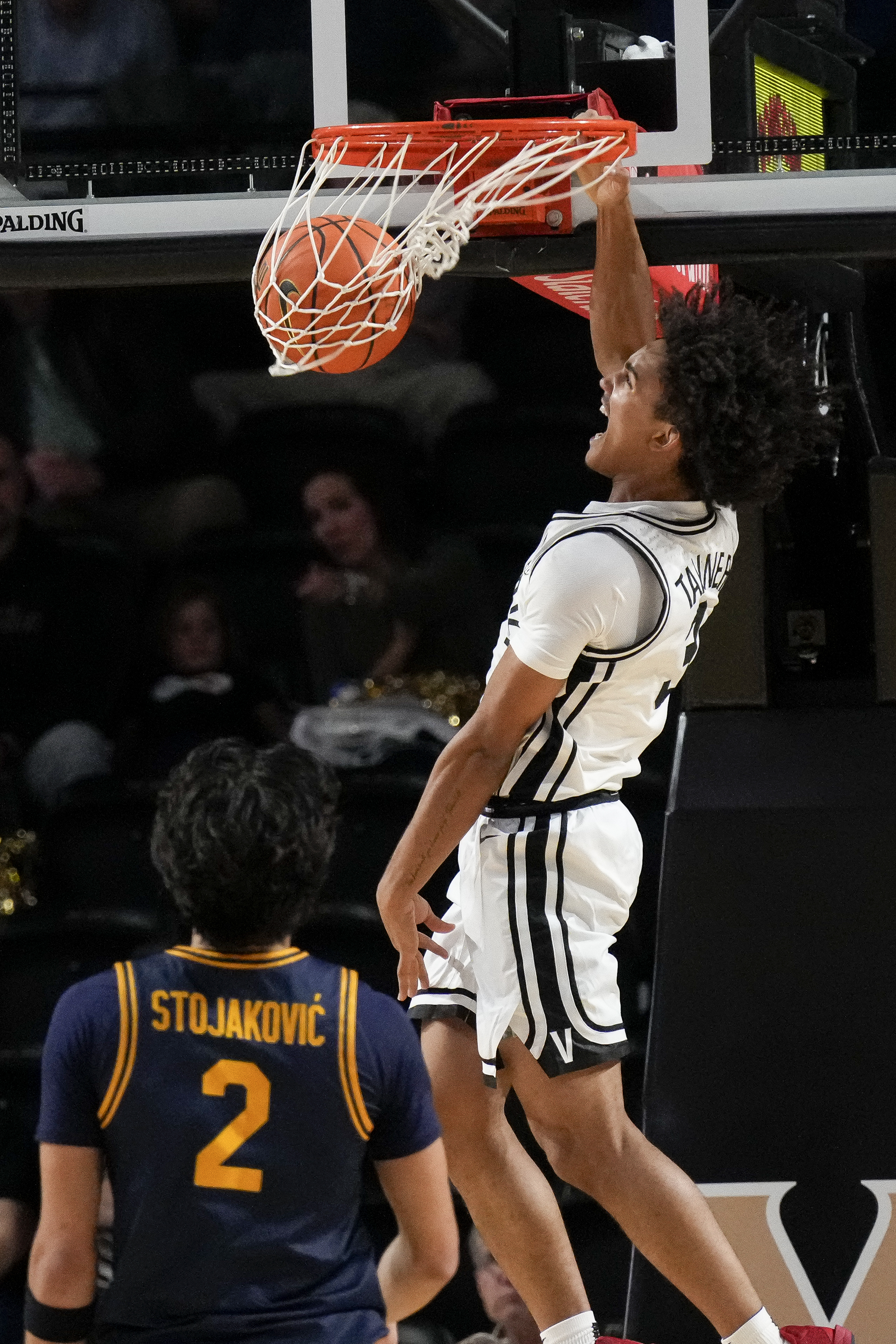 Vanderbilt guard Tyler Tanner (3) dunks the ball over California guard Andrej Stojakovic (2) during the first half of an NCAA college basketball game Wednesday, Nov. 13, 2024, in Nashville, Tenn.