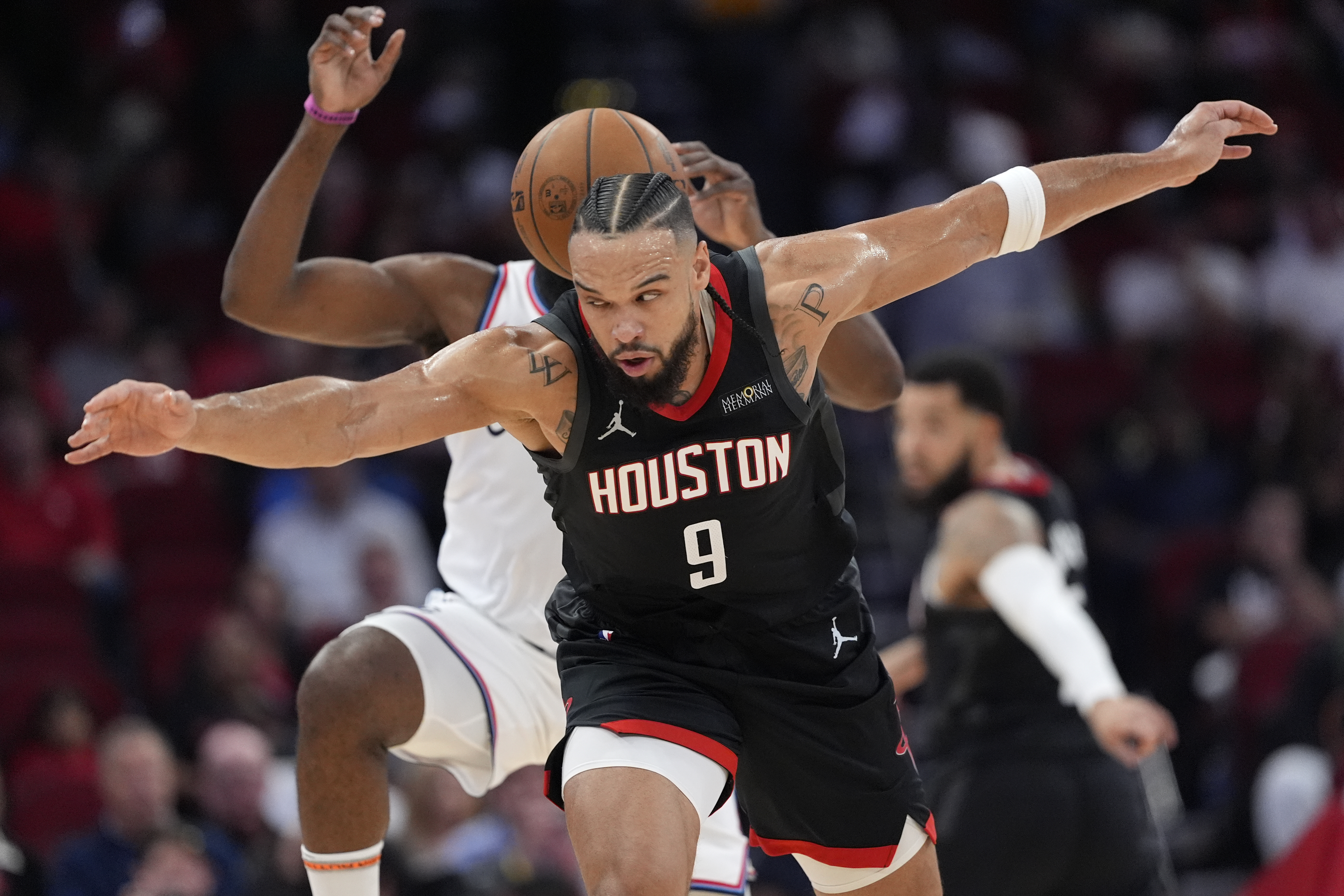 Houston Rockets' Dillon Brooks (9) tries to steal the ball from Los Angeles Clippers' James Harden during the first half of an NBA basketball game Wednesday, Nov. 13, 2024, in Houston.