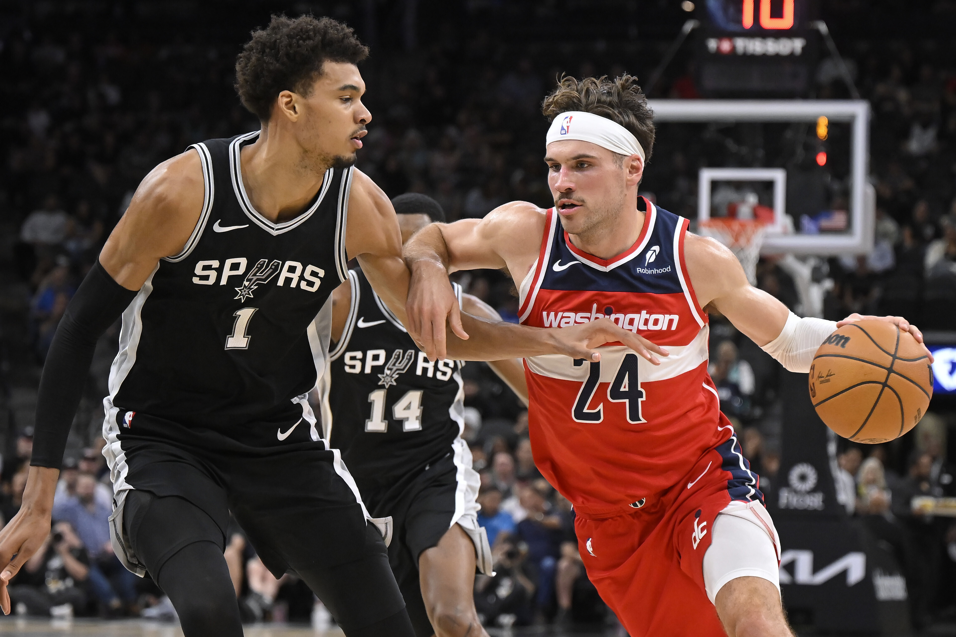 Washington Wizards' Corey Kispert (24) drives against San Antonio Spurs' Victor Wembanyama during the first half of an NBA basketball game, Wednesday, Nov. 13, 2024, in San Antonio.