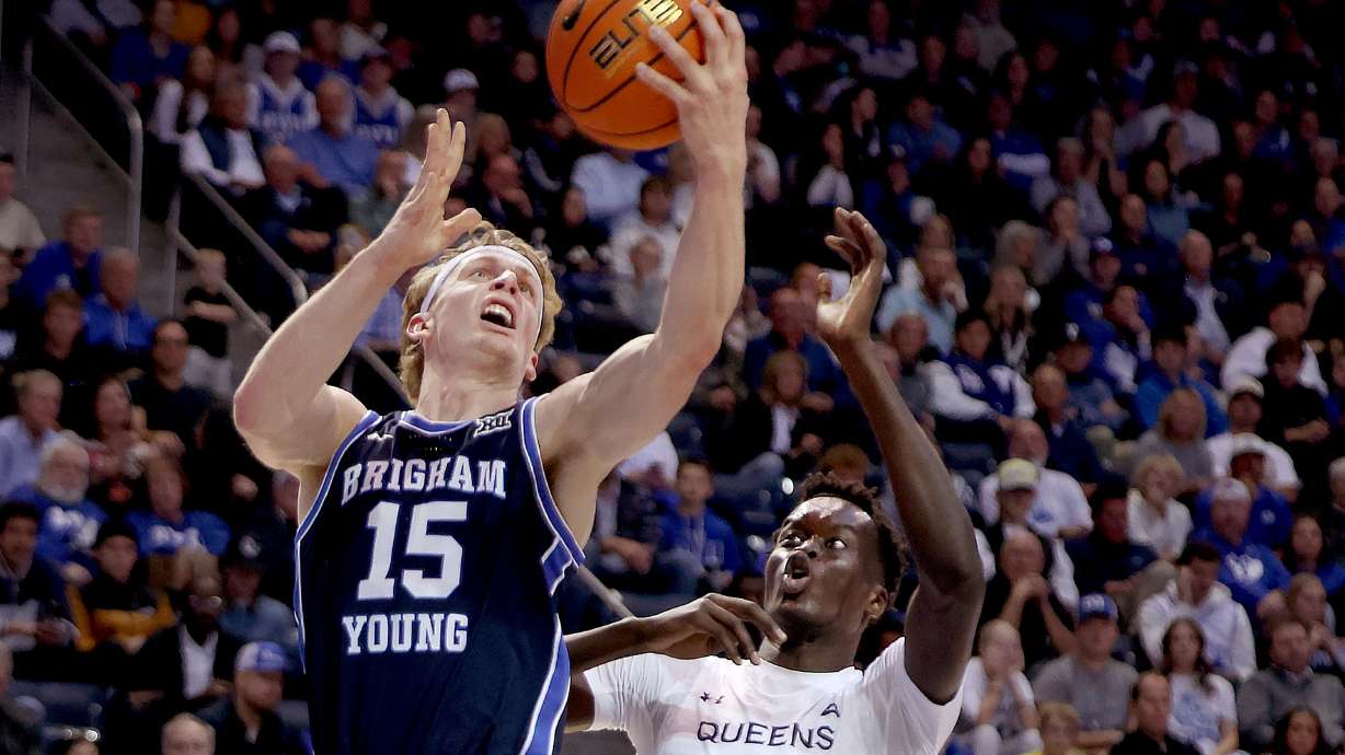 Brigham Young forward Richie Saunders (15) shoots past Queens Royals' Maban Jabriel (9) at the Marriott Center in Provo on Wednesday, Nov. 13, 2024.