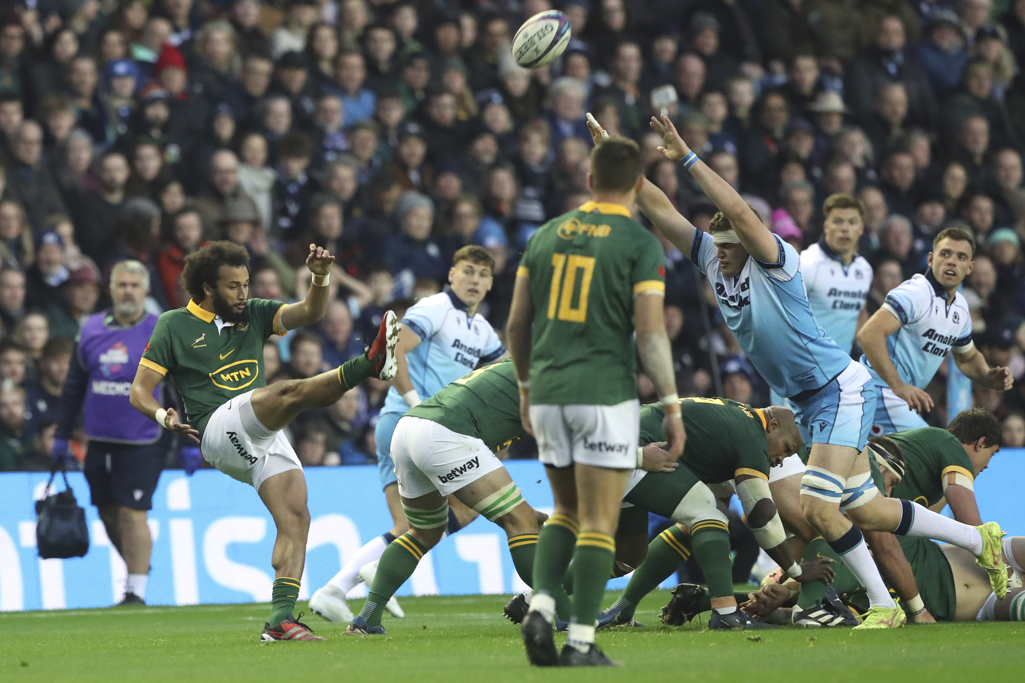 South Africa's Jaden Hendrikse, left, kicks the ball clears the ball as Scotland's Scott Cummings, right, attempts to charge the ball down during the Autumn Nations series rugby union match between Scotland and South Africa in Edinburgh, Scotland, Sunday, Nov. 10, 2024.