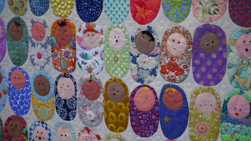 Chris Manning's "Baby Born" quilt is displayed ahead of a quilt show this weekend. The quilt show displays only hand-quilted quilts and is hosted by Intermountain Foundation. It raises funds for Primary Children's Hospital's fetal center.