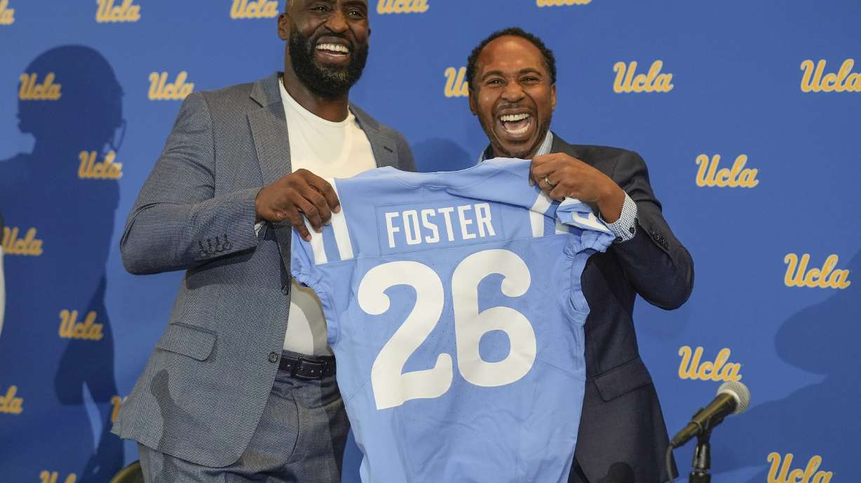 FILE - New UCLA NCAA college football head coach DeShaun Foster, left, poses with UCLA athletic director Martin Jarmond during an introductory press conference at Pauley Pavilion on the UCLA campus in Los Angeles, Feb. 13, 2024.