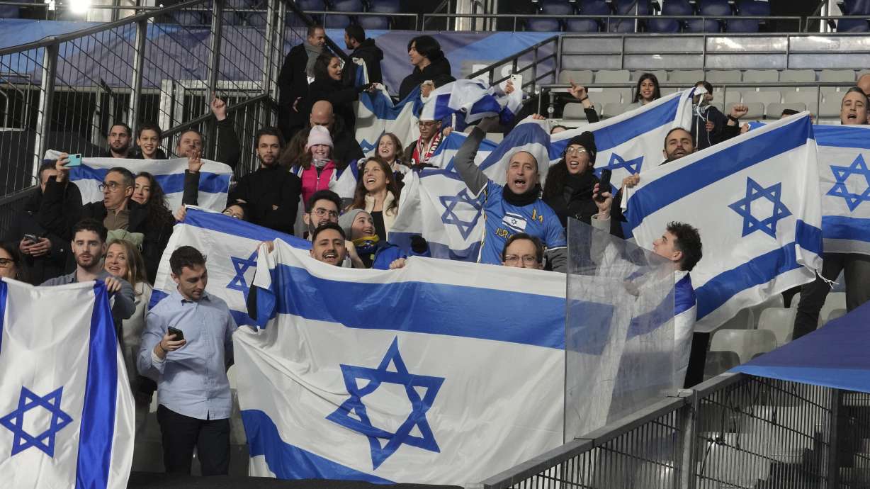 Israeli supporters display their national flag before the UEFA Nations League soccer match between France and Israel at the Stade de France stadium in Saint-Denis, outside Paris, Thursday Nov. 14, 2024.