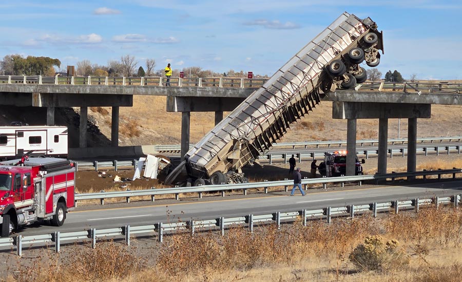 Emergency crews are on the scene of a crash involving a semitruck that is partly off a bridge above Interstate 84 at Exit 226 near Declo in southeastern Idaho. 