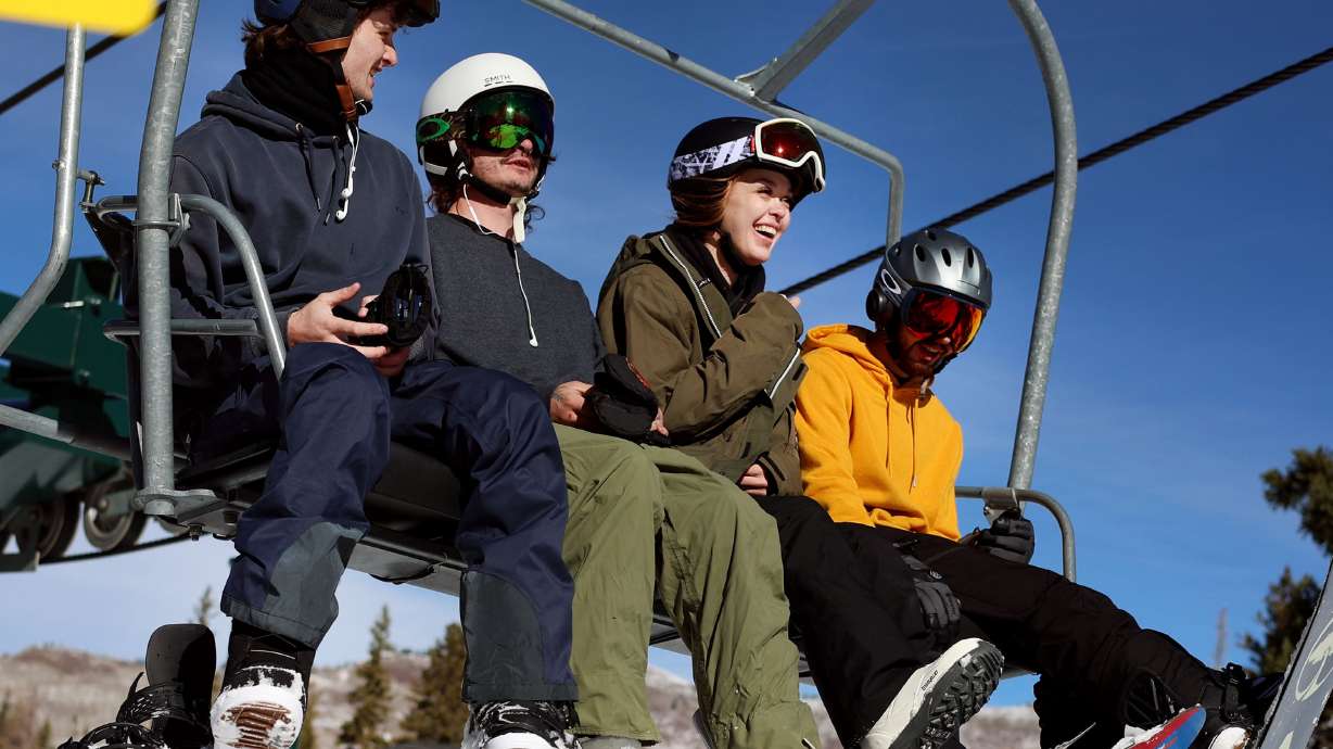 People ski and snowboard at the grand opening of the season at Brighton Resort in Big Cottonwood Canyon on Thursday. The resort opened Thursday ahead of a snowstorm expected to bring as much as 10 inches of powder.