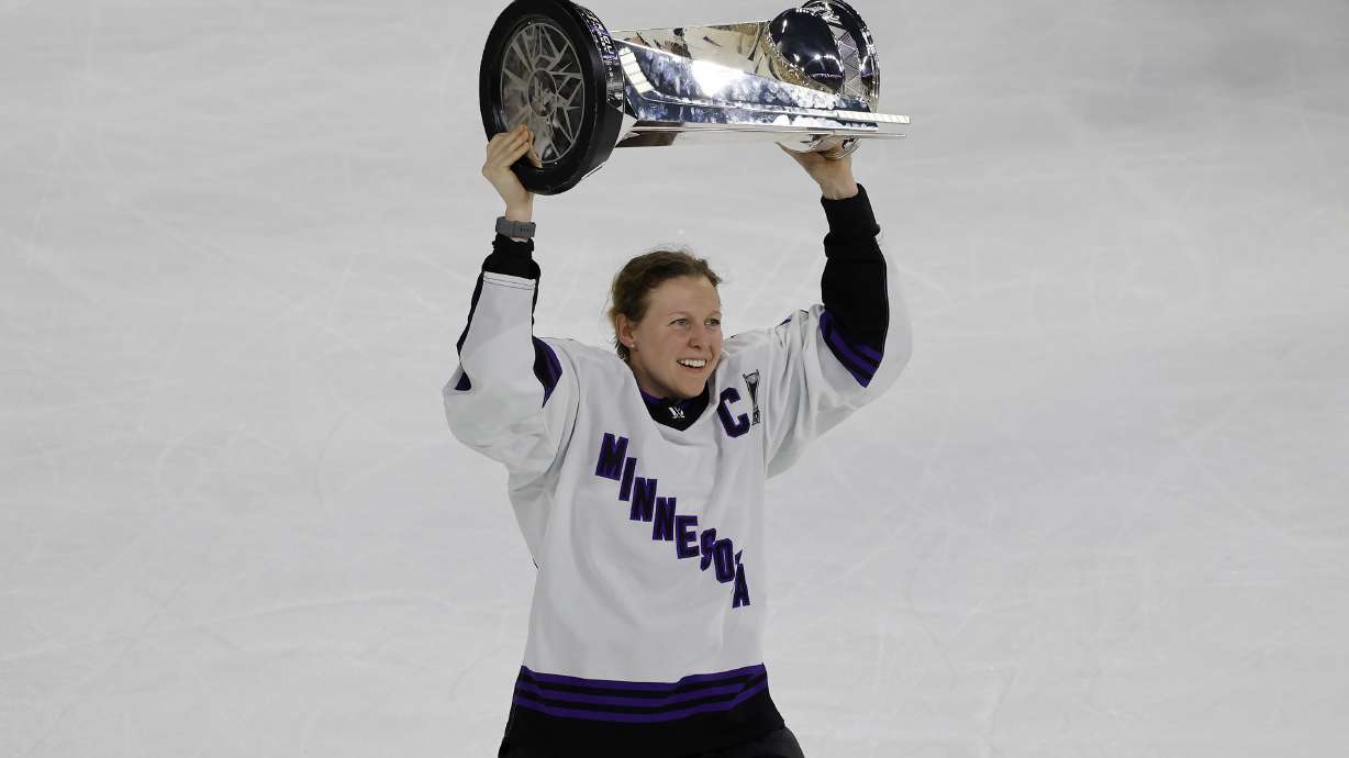 FILE - Minnesota captain Kendall Coyne Schofield celebrates with the trophy after beating Boston in Game 5 of the PWHL Walter Cup hockey finals, May 29, 2024, in Lowell, Mass.