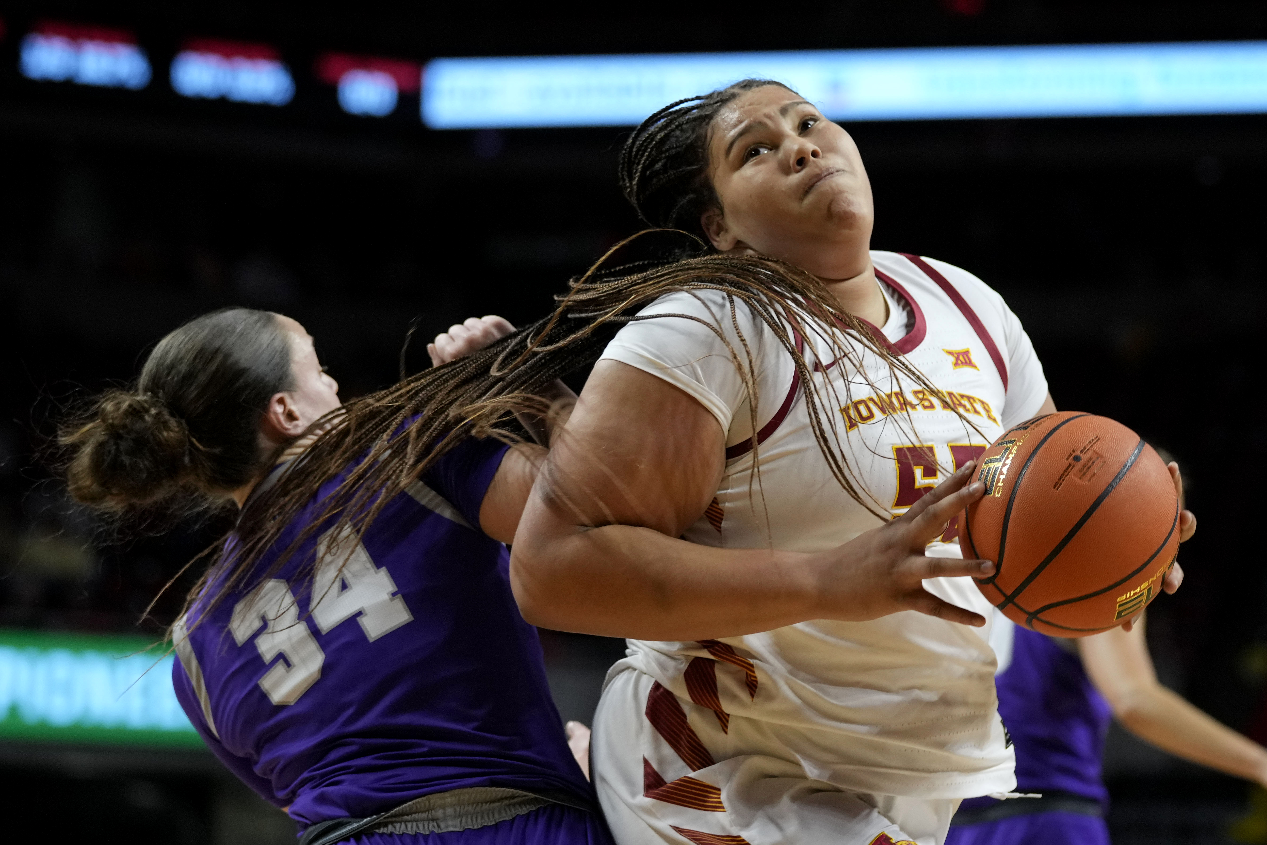 Iowa State center Audi Crooks, right, drives around St. Thomas center Jo Langbehn (34) during the first half of an NCAA college basketball game, Thursday, Nov. 14, 2024, in Ames, Iowa.