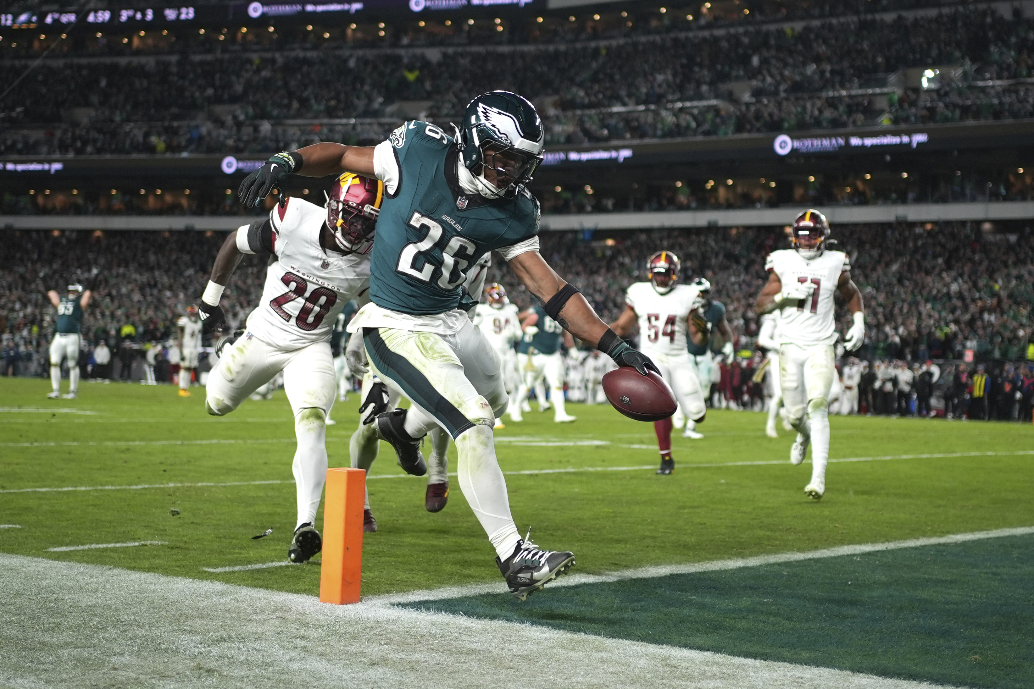 Philadelphia Eagles running back Saquon Barkley (26) scores during the second half of an NFL football game against the Washington Commanders Thursday, Nov. 14, 2024, in Philadelphia.