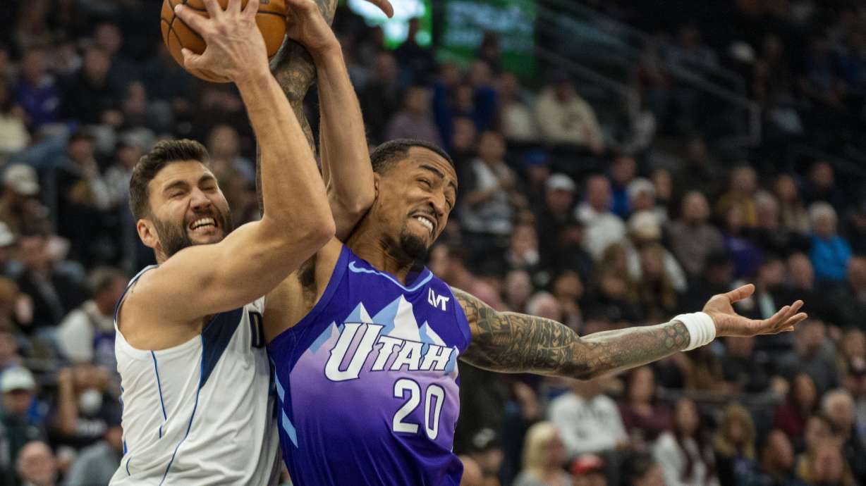 Dallas Mavericks forward Maxi Kleber, left, gets tangled up with Utah Jazz forward John Collins (20) during the first half of an NBA basketball game Thursday, Nov. 14, 2024, in Salt Lake City.