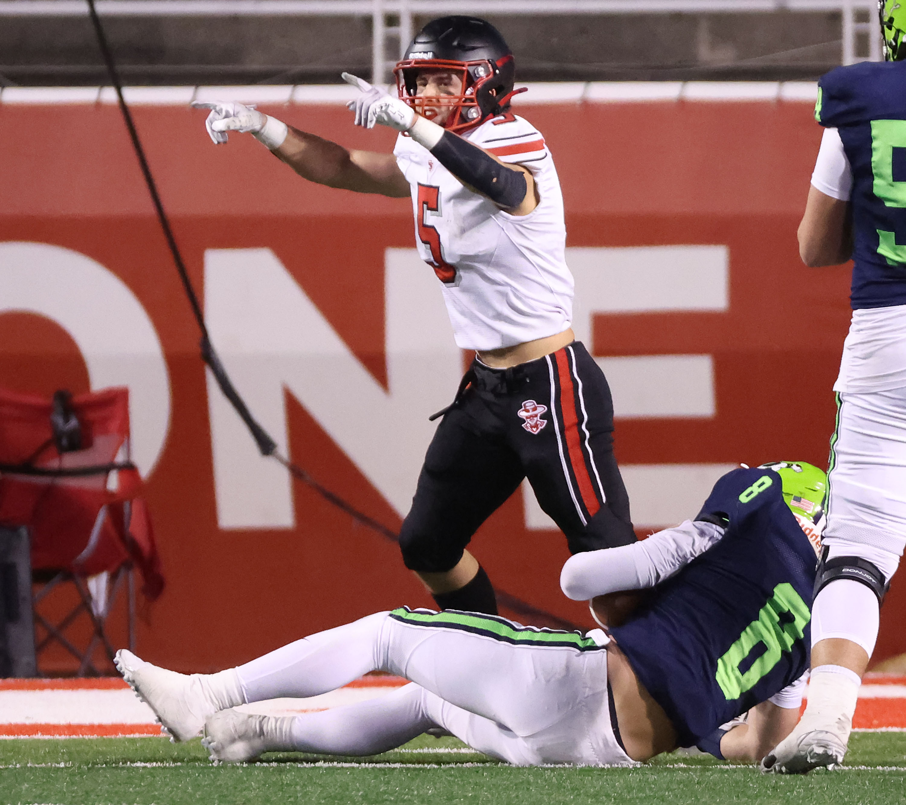 Spanish Fork’s Kaden Vest (5) celebrates a sack on Ridgeline QB Nate Dahle (8) in the 4A semifinal game in Salt Lake City on Thursday, Nov. 14, 2024.