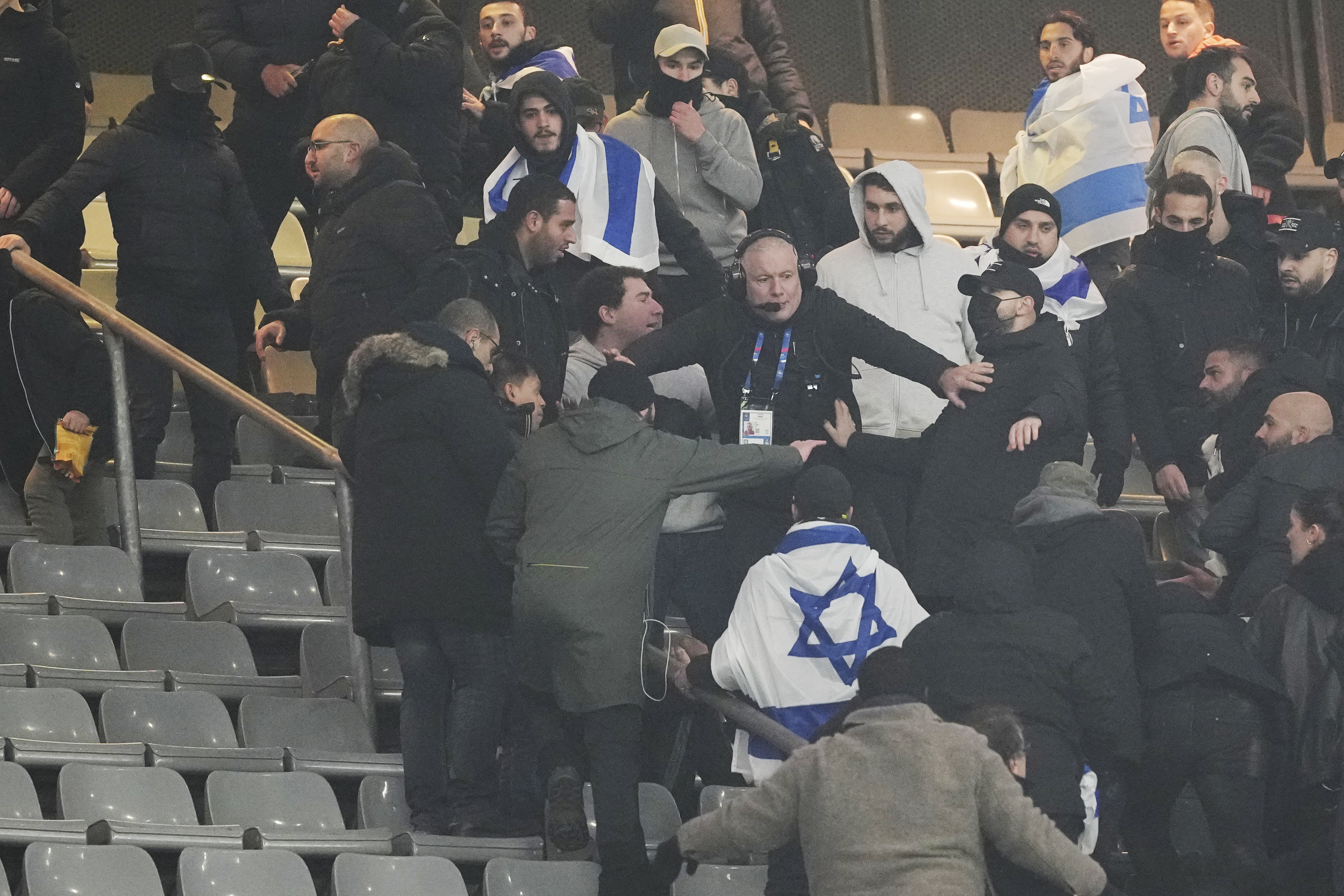 Fans argue on stands during the UEFA Nations League soccer match between France and Israel at the Stade de France stadium in Saint-Denis, outside Paris, Thursday Nov. 14, 2024. 