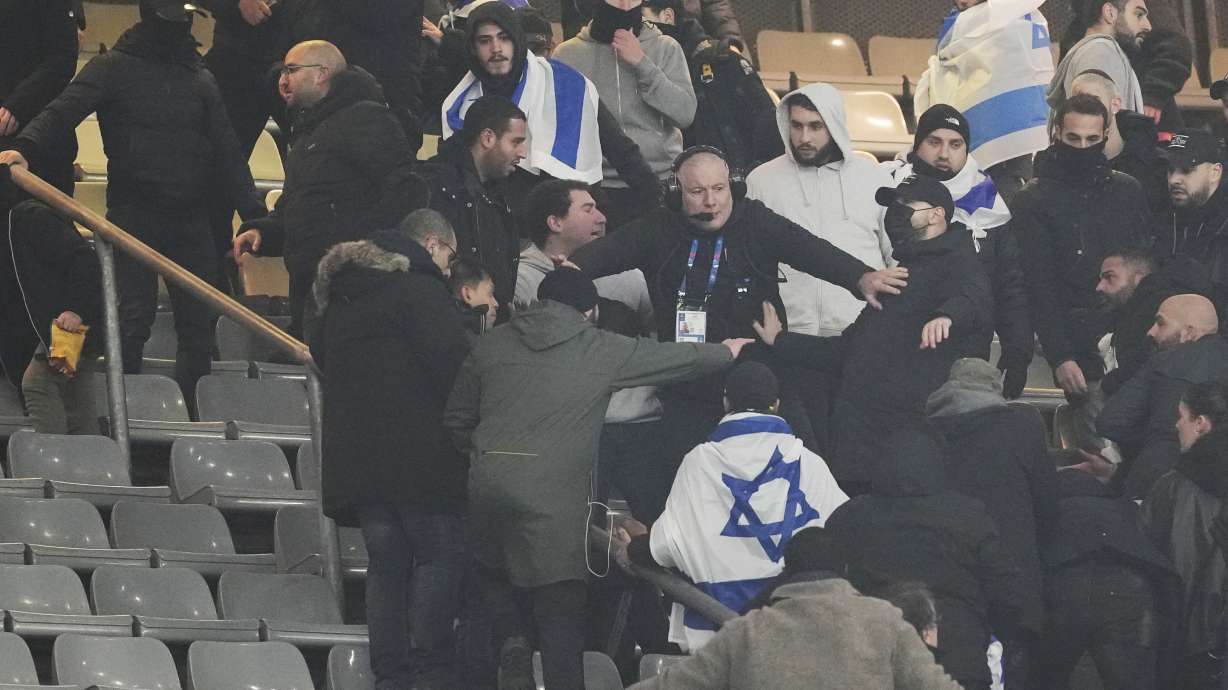 Fans argue on stands during the UEFA Nations League soccer match between France and Israel at the Stade de France stadium in Saint-Denis, outside Paris, Thursday Nov. 14, 2024.