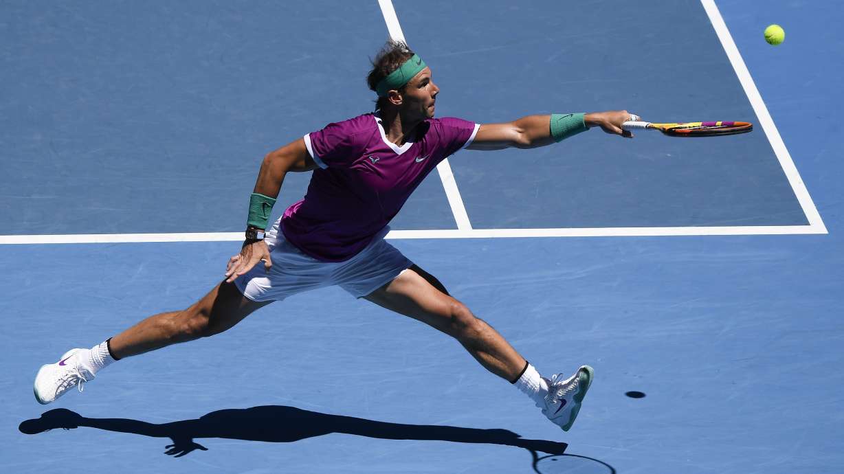 FILE - Rafael Nadal of Spain plays a backhand return to Yannick Hanfmann of Germany during their second round match at the Australian Open tennis championships in Melbourne, Australia, Jan. 19, 2022.