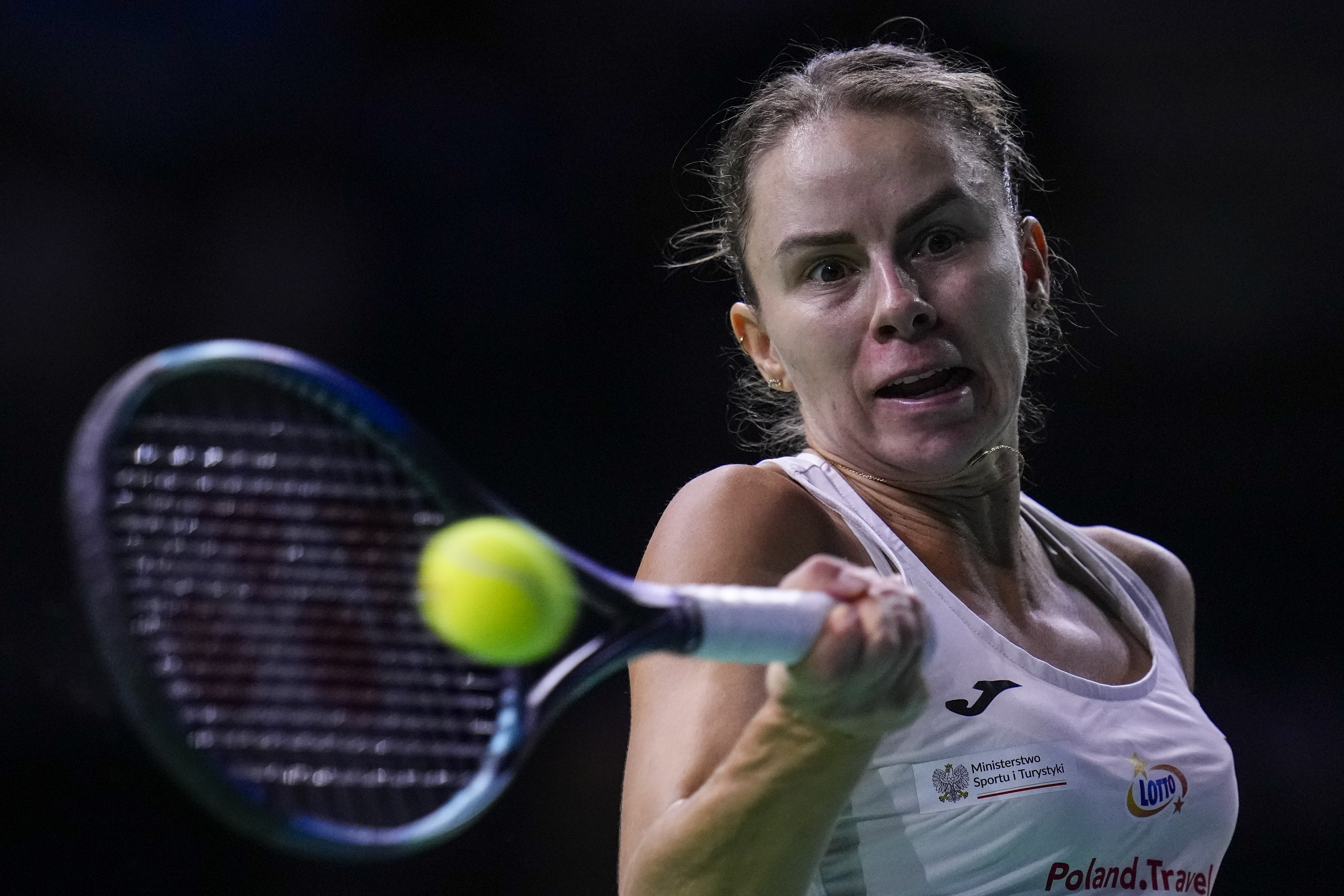 Poland's Magda Linette returns the ball against Spain's Sara Sorriber Tormo during the Billie Jean King Cup Finals, at the Martin Carpena Sports Hall, in Malaga, southern Spain, on Friday, Nov. 15, 2024.