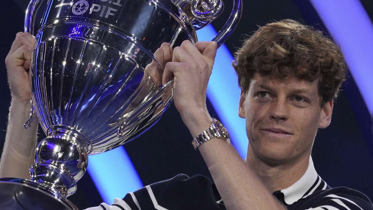 Italy's Jannik Sinner holds the trophy as ATP world best player at the ATP World Tour Finals at the Inalpi Arena, in Turin, Italy, Monday, Nov. 11, 2024. Sinner was presented with the trophy for finishing the year ranked No. 1.