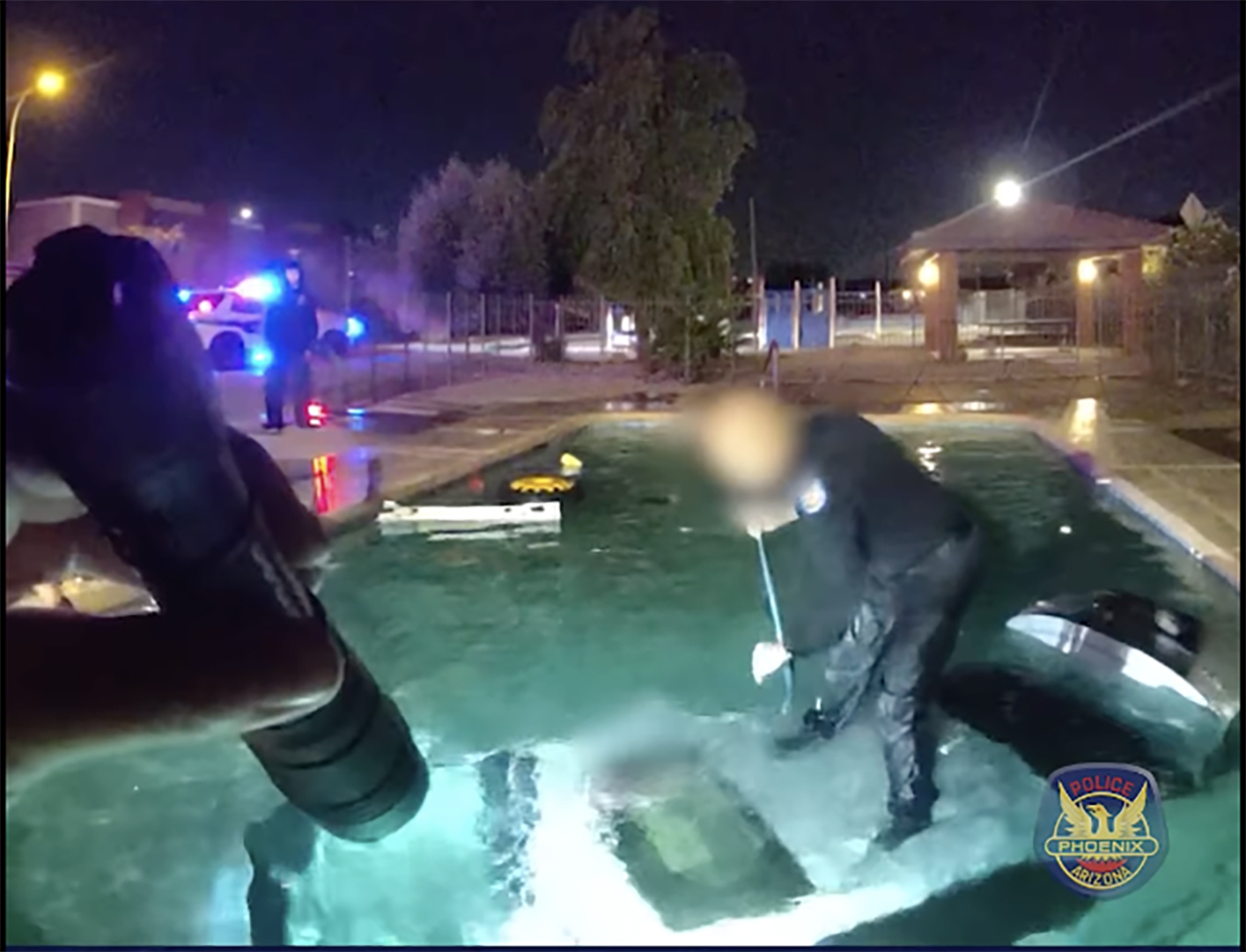 Bodycam video shows a Phoenix police officer saving a motorist from a car submerged in a swimming pool, Oct. 31.