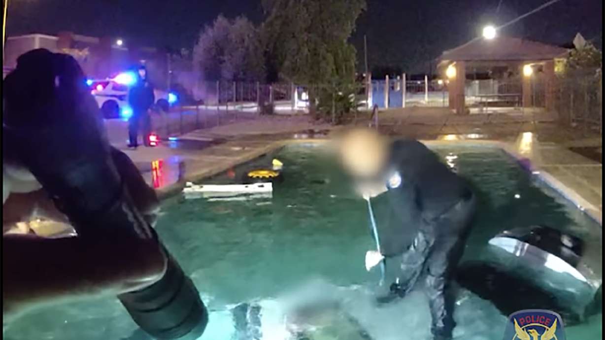 Bodycam video shows a Phoenix police officer saving a motorist from a car submerged in a swimming pool, Oct. 31.