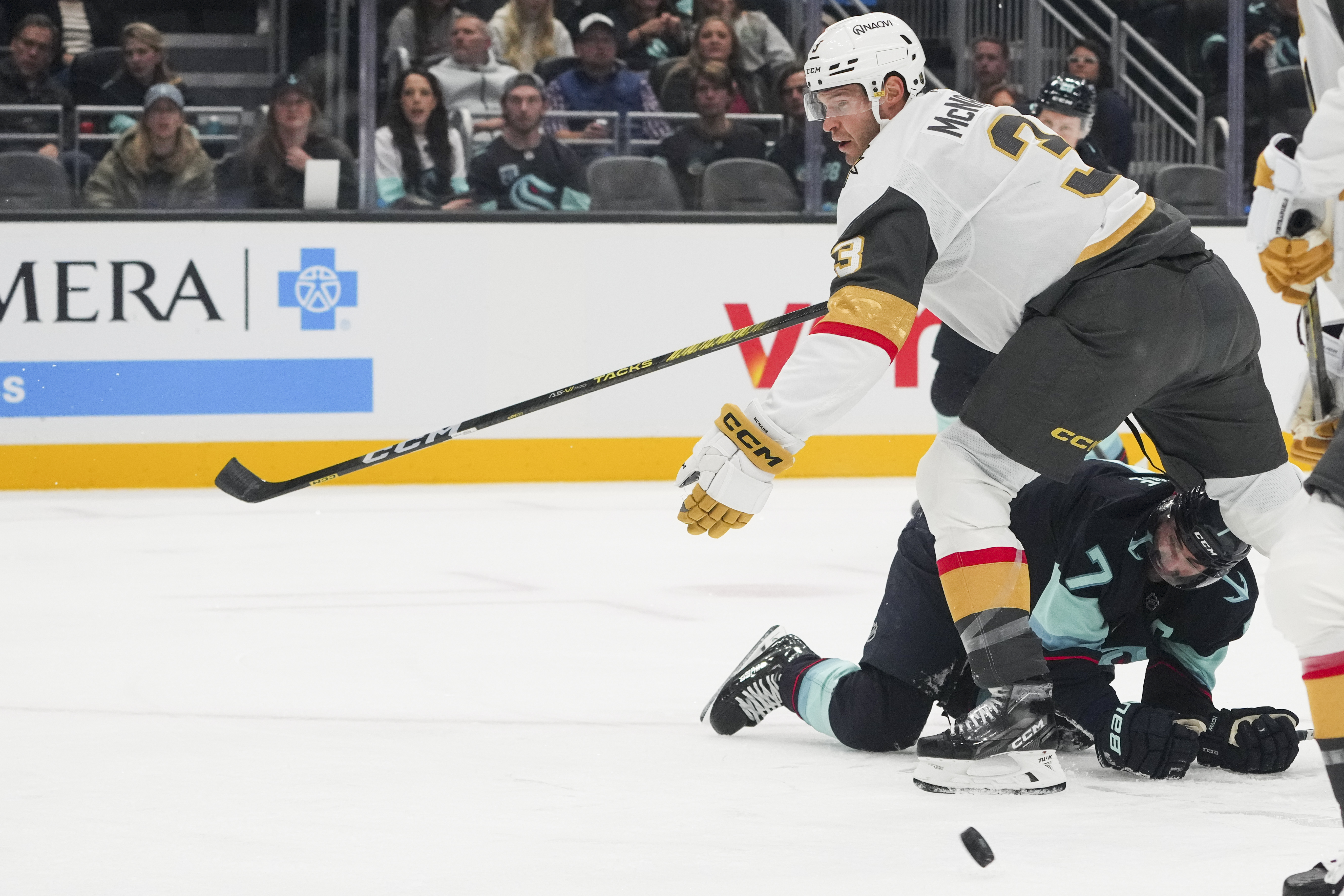 Seattle Kraken right wing Jordan Eberle (7) looks on after falling over while colliding with Vegas Golden Knights defenseman Brayden McNabb, top, during the first period of an NHL hockey game Friday, Nov. 8, 2024, in Seattle. 
