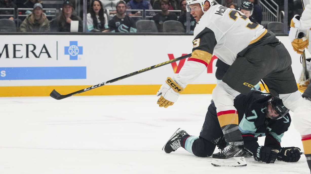 Seattle Kraken right wing Jordan Eberle (7) looks on after falling over while colliding with Vegas Golden Knights defenseman Brayden McNabb, top, during the first period of an NHL hockey game Friday, Nov. 8, 2024, in Seattle.