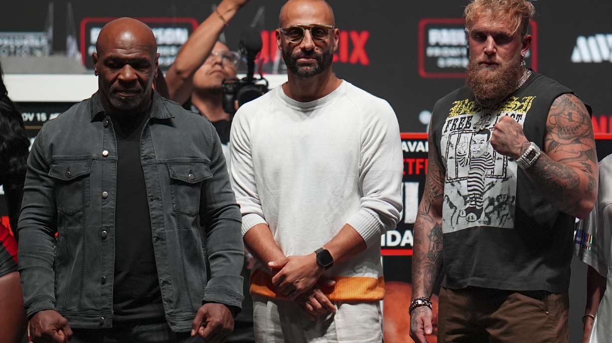 Mike Tyson, left, and Jake Paul, right, pose for photographs during a news conference ahead of their fight, Wednesday, Nov. 13, 2024, in Irving, Texas.